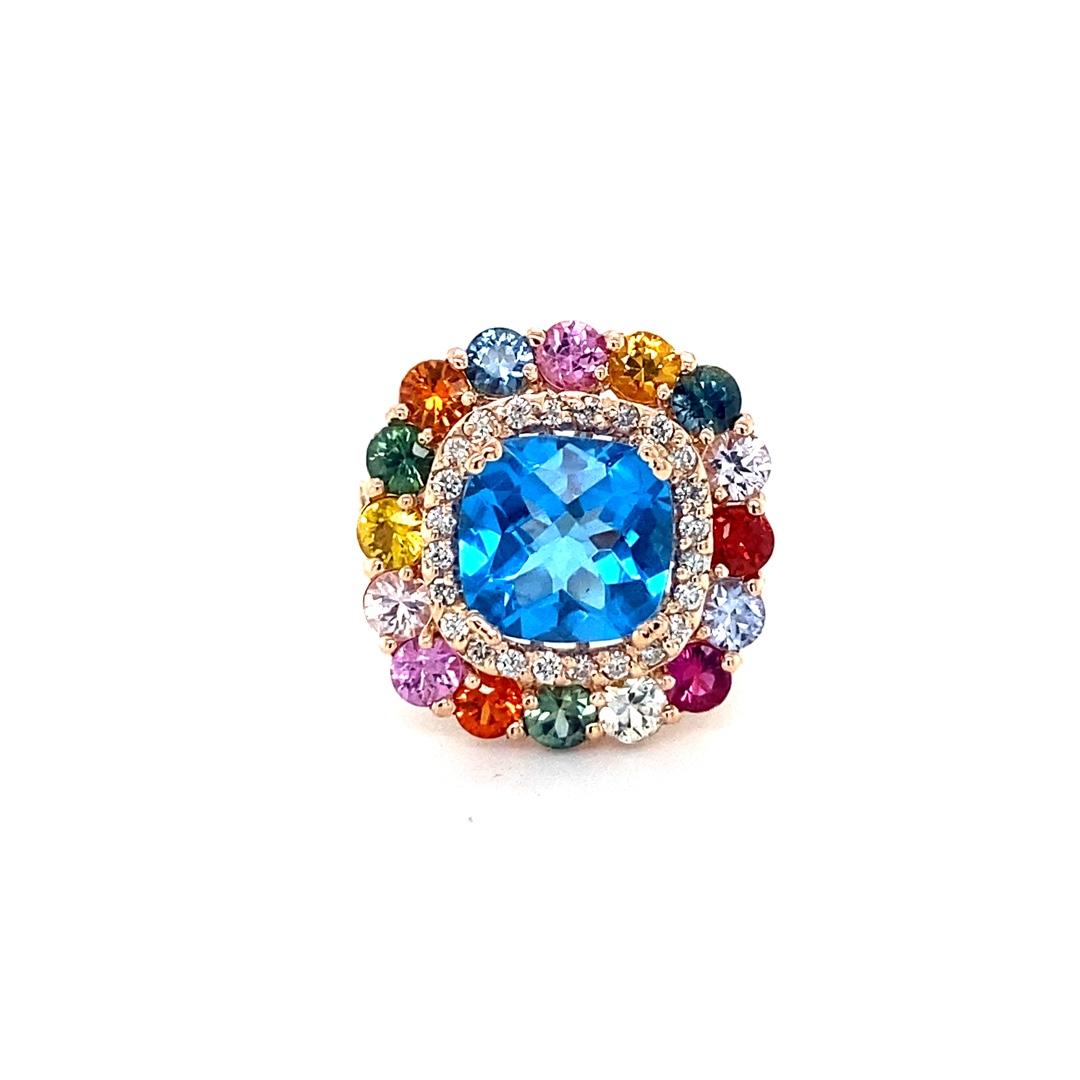 Beautiful to say the Least! 

This Ring has a magnificent Cushion Cut Blue Topaz that weighs 4.33 carats and is surrounded by 16 Round Cut Multi Colored Sapphires that weigh 2.91  carats and 38 Round Cut Diamonds that weigh 0.50 Carats (Clarity: SI,