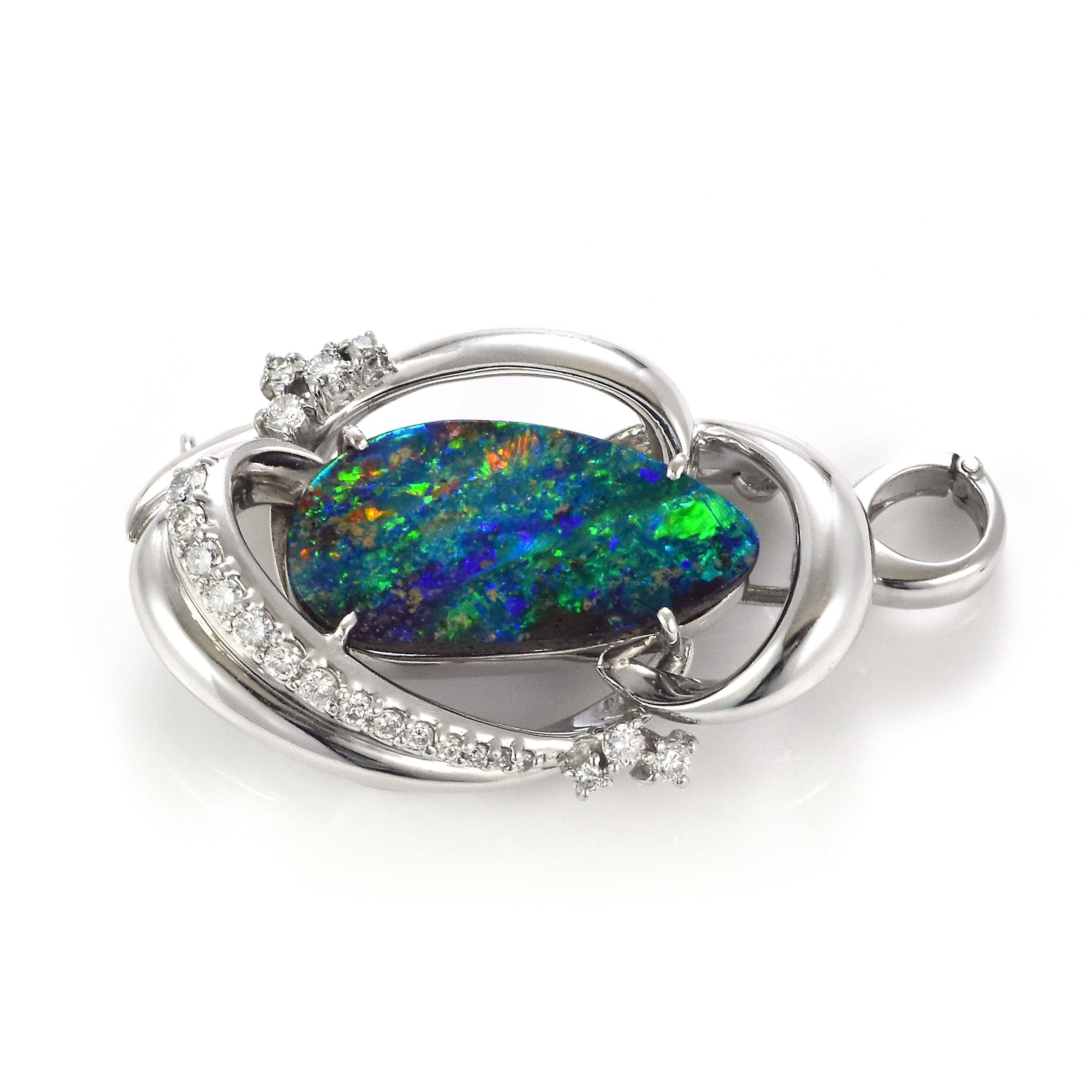 A beautiful pendant top featuring a 7.74 Carat Australian Boulder Opal and 0.48 Carat Diamonds made in Platinum. The Opal displays very good play of color! Opals are known for exhibiting flashes of rainbow colors known as 