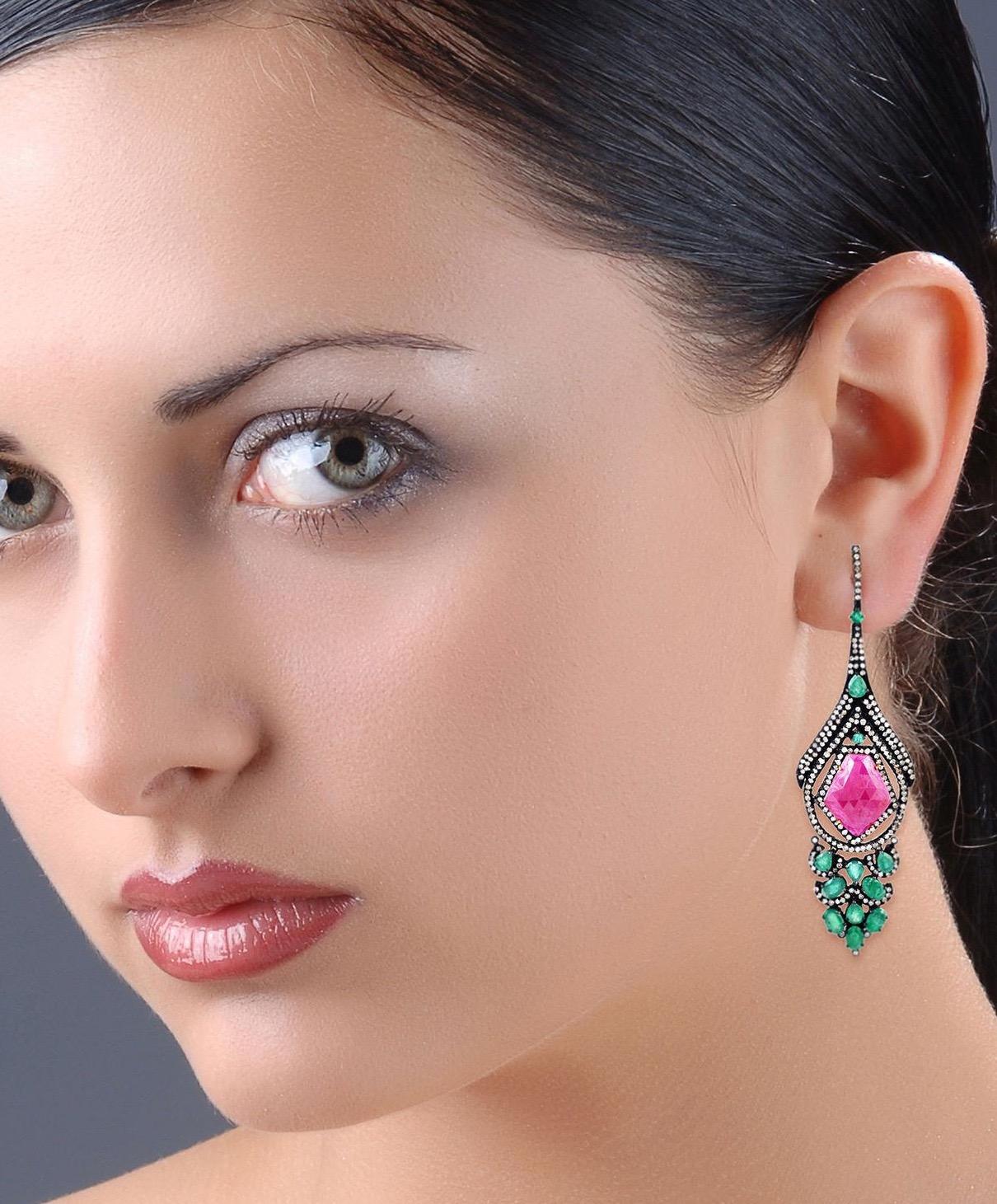 Handcrafted from 14-karat gold and sterling silver, these beautiful earrings are set with 19.3 carats ruby, 7.74 carats emerald and 4.5 carats of glimmering diamonds with blackened finish.

FOLLOW  MEGHNA JEWELS storefront to view the latest