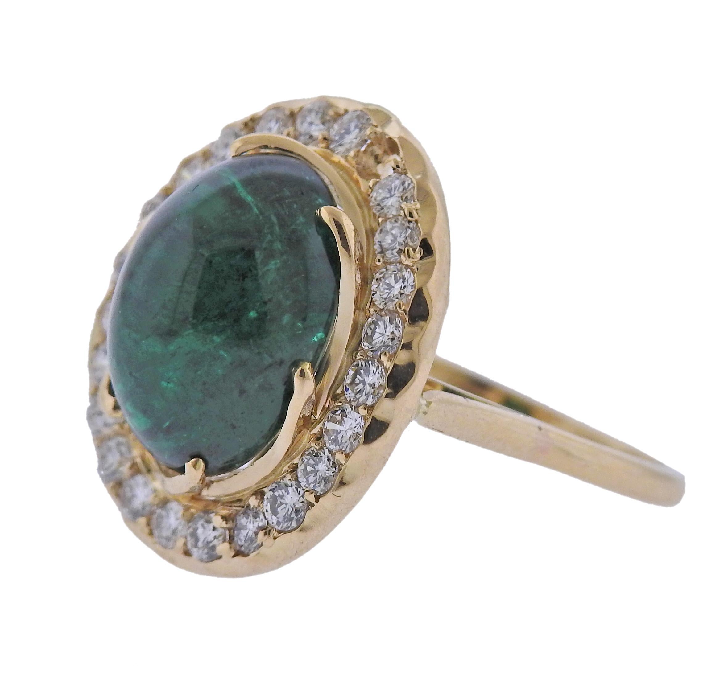 18k gold cocktail ring, with center approx. 7.75ct emerald cabochon (stone measures approx. 13.65 x 10.55 x 7.2mm) surrounded with approx. 0.72ctw in diamonds (one stone is missing). Ring size - 7, ring top is 20mm x 17mm. Marked: 750. Weight - 8.1