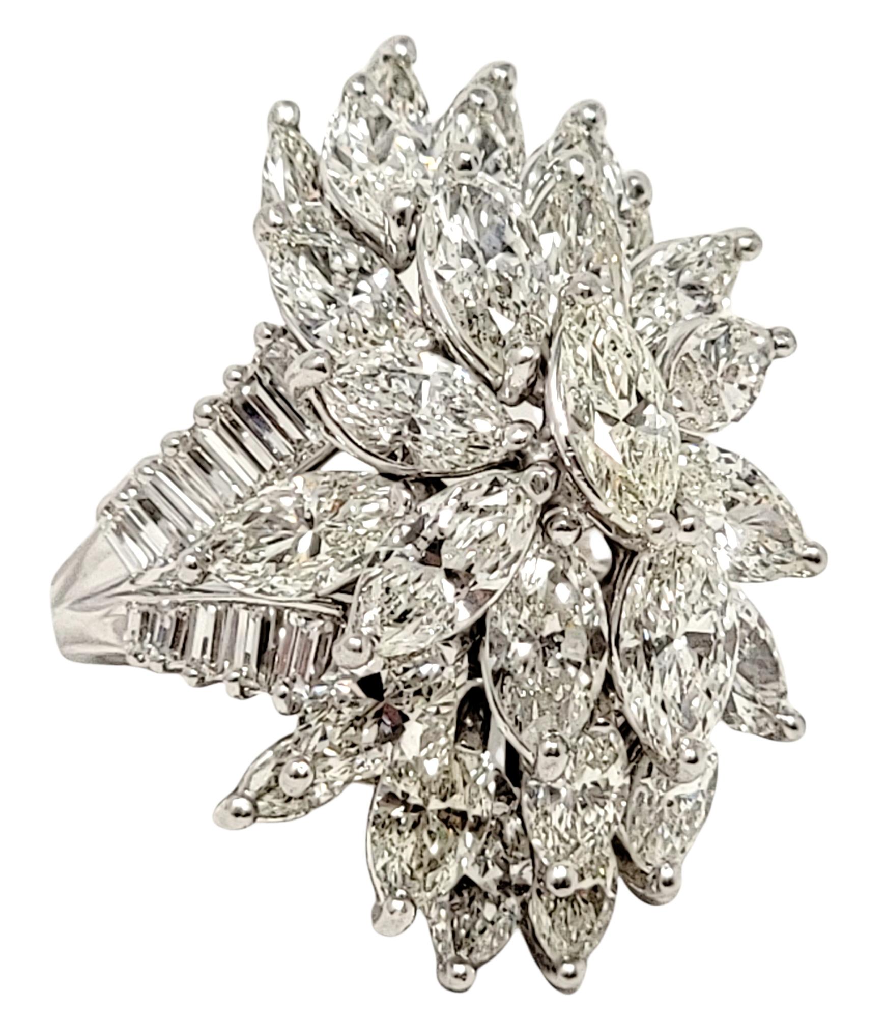 Ring size: 5

Breathtaking bold diamond cluster ring shimmers with incredible sparkle from every angle! The intricate tiered design of the glittering diamonds sits high off the finger, demanding the viewers attention. It features 29 marquis