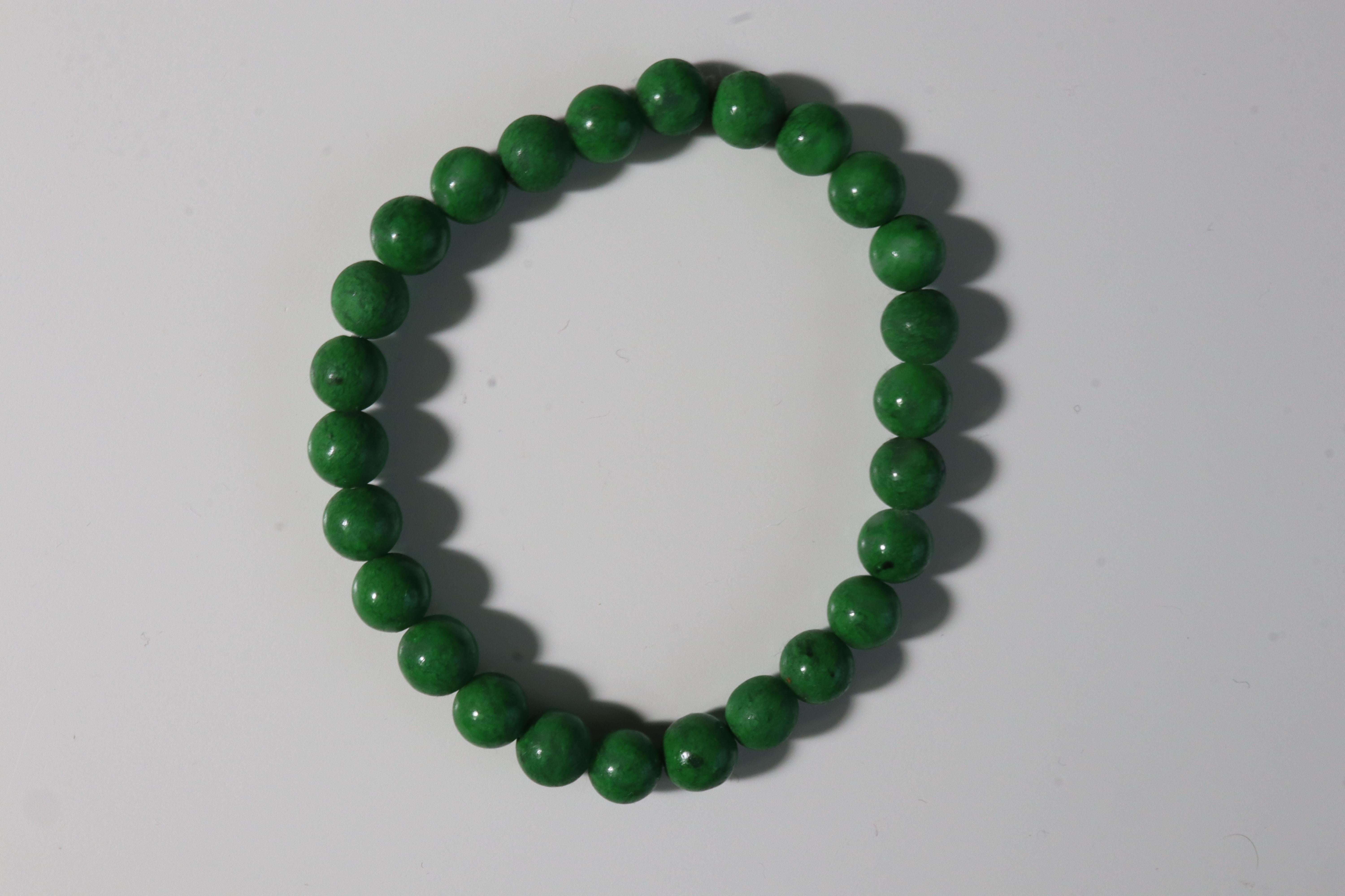 Rare genuine non-treated Natural Maw Sit-Sit round Beads bracelet, beautiful green and dark vein.

Maw sit sit is a vibrant, distinctive green and black color gem material that has been confused with jade for hundreds of years.

It is much rare than