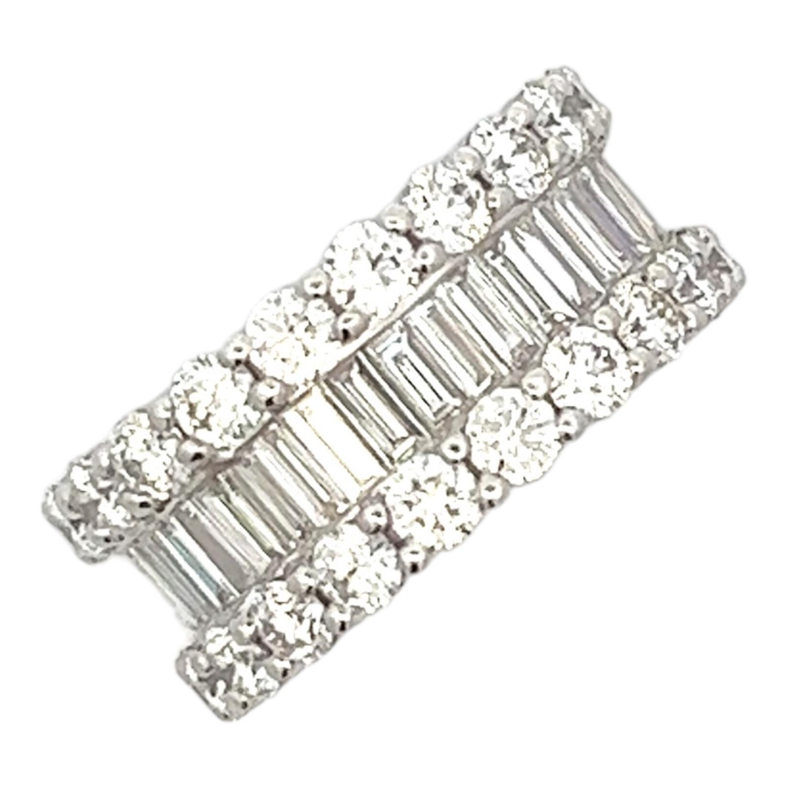 Beautiful wide diamond eternity wedding band handcrafted in 18 karat white gold. The band features 42 baguette and 42 round brilliant cut diamonds weighing approximately 7.76 carat total weight and graded G color and VS1 clarity. The band measures