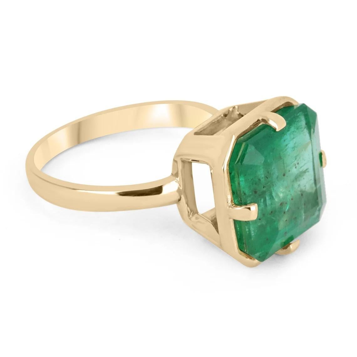 Displayed is a one of a kind, natural emerald solitaire Asscher-cut engagement ring/right-hand ring in 18K yellow gold. This gorgeous solitaire ring carries a full 7.76-carat emerald in a four-prong setting. Fully faceted, this gemstone showcases