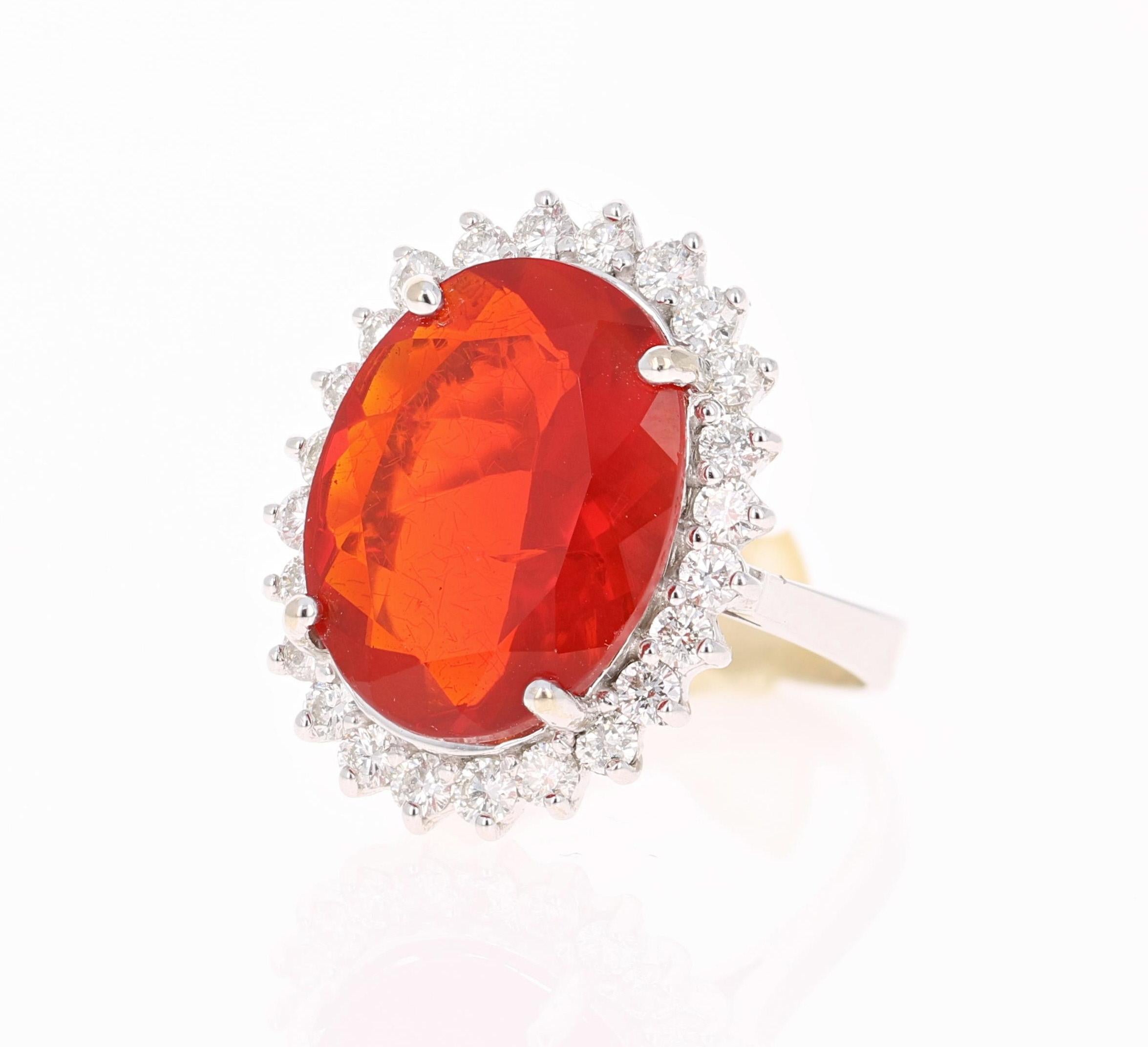 Beautiful Fire Opal and Diamond Ring. This ring has an Oval Cut Fire Opal that weighs 6.81 carats in the center of the ring and is surrounded by a halo of 24 Round Cut Diamonds that weigh 0.96 carats (Clarity: VS2, Color: H).  The total carat weight