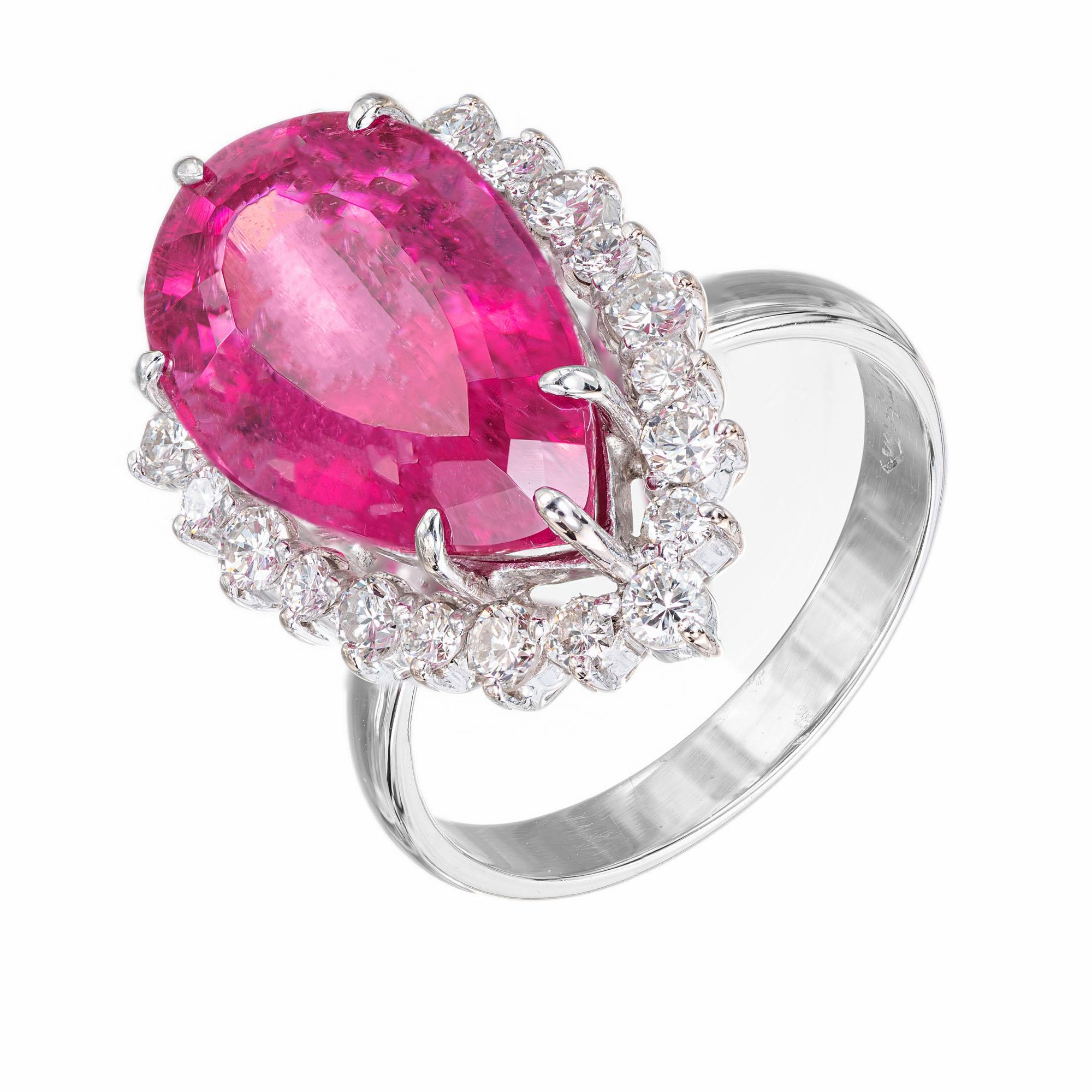 Pear shape bright pink tourmaline and diamond cocktail ring. 7.77 carat center pear shaped tourmaline, moderate inclusions with a halo of 22 round brilliant cut diamonds in a 14k white gold setting.  

1 pear shape pink tourmaline, MI approx.