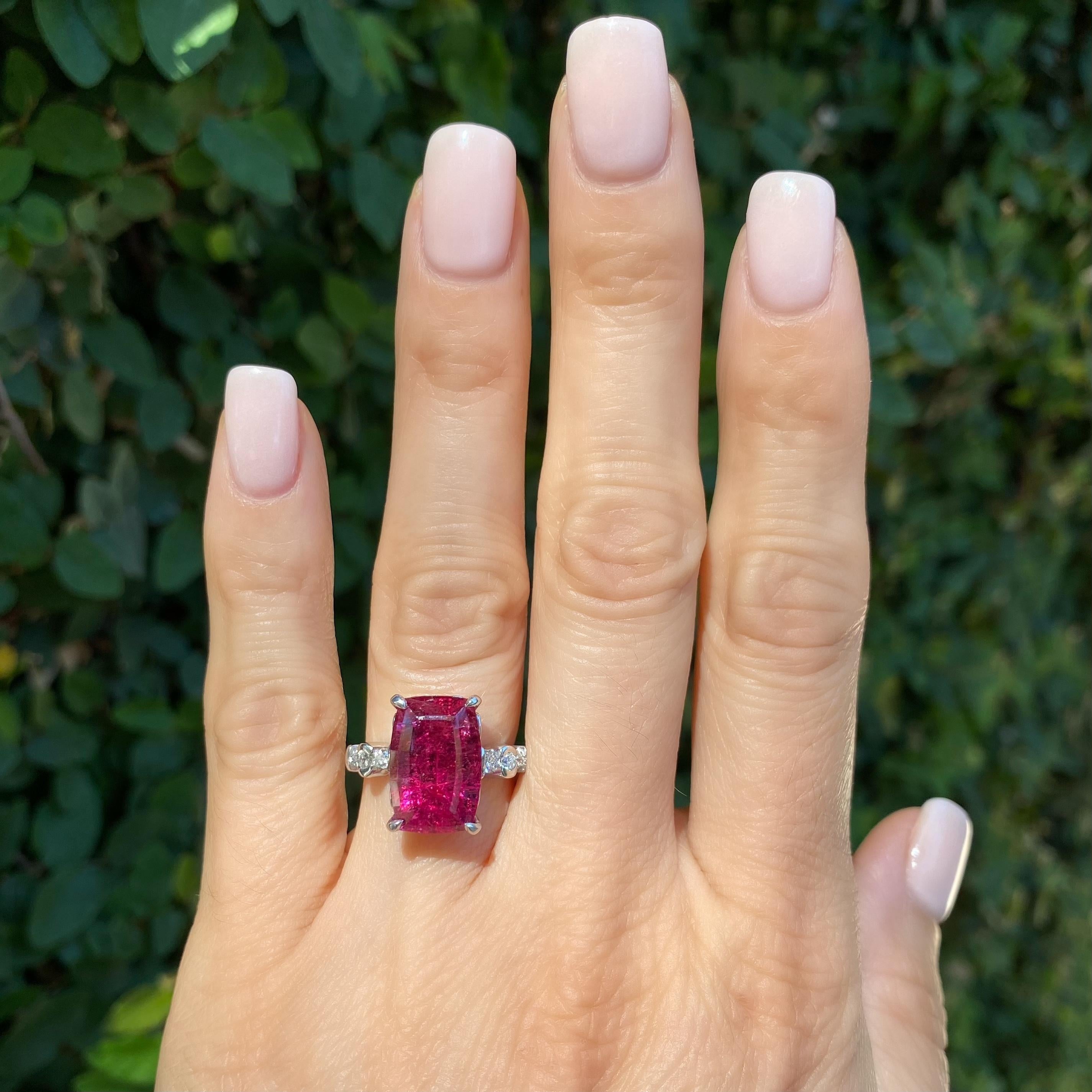 Awesome Fancy Raspberry Red Rubelite Tourmaline and Diamond Platinum Ring. Center Hand set with a securely nestled, rectangular 7.77 Carat Rubelite Tourmaline, accented by 6 round brilliant cut Diamonds, approx. 0.28tcw. Dimensions: 0.81”w x 0.57”h