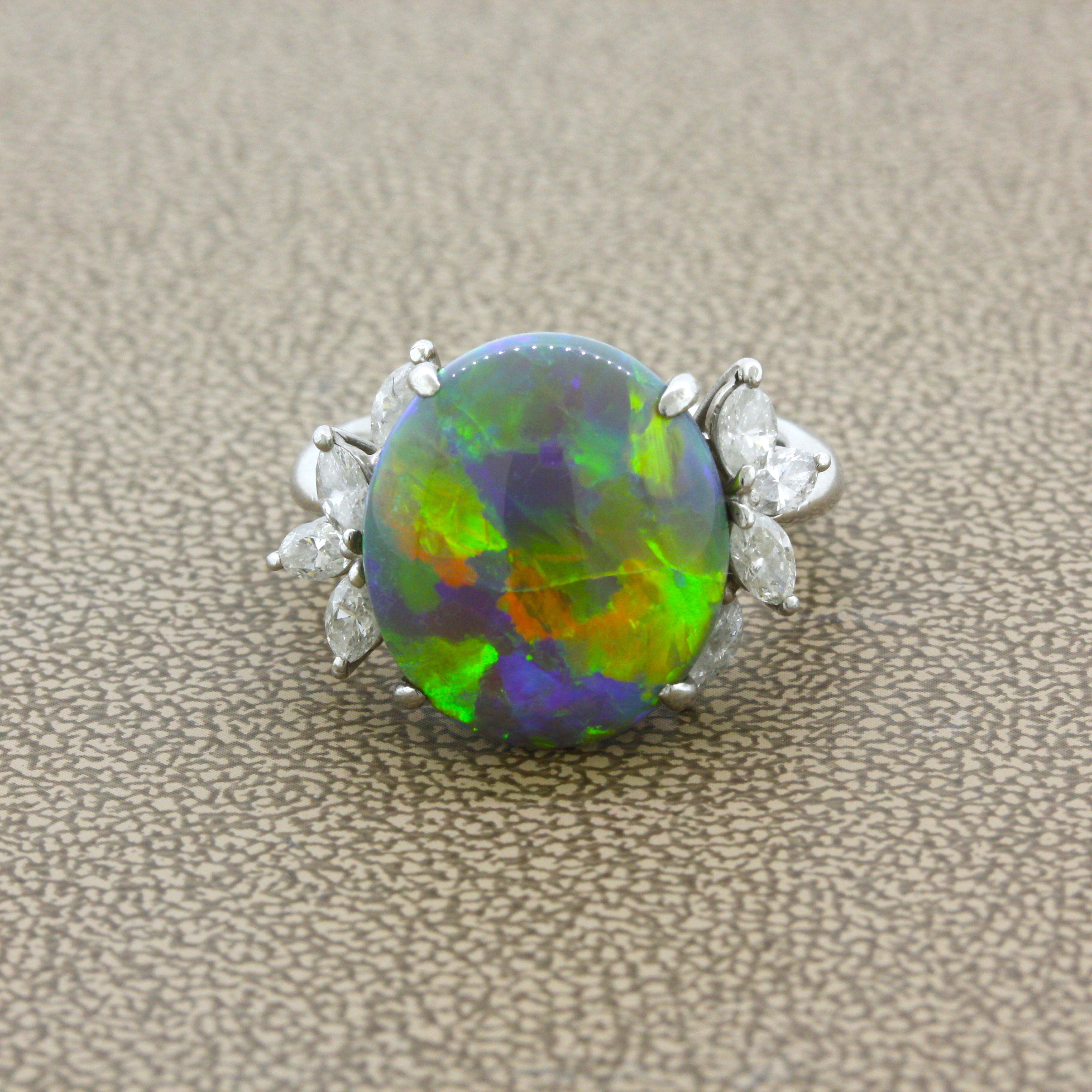 A very fine gem, this black crystal opal from Australia weighs an impressive 7.78 carats. It has amazing play-of-color as large and bright swaths of color flash across the stone, with primary colors of orange, green and yellow, along with blues and