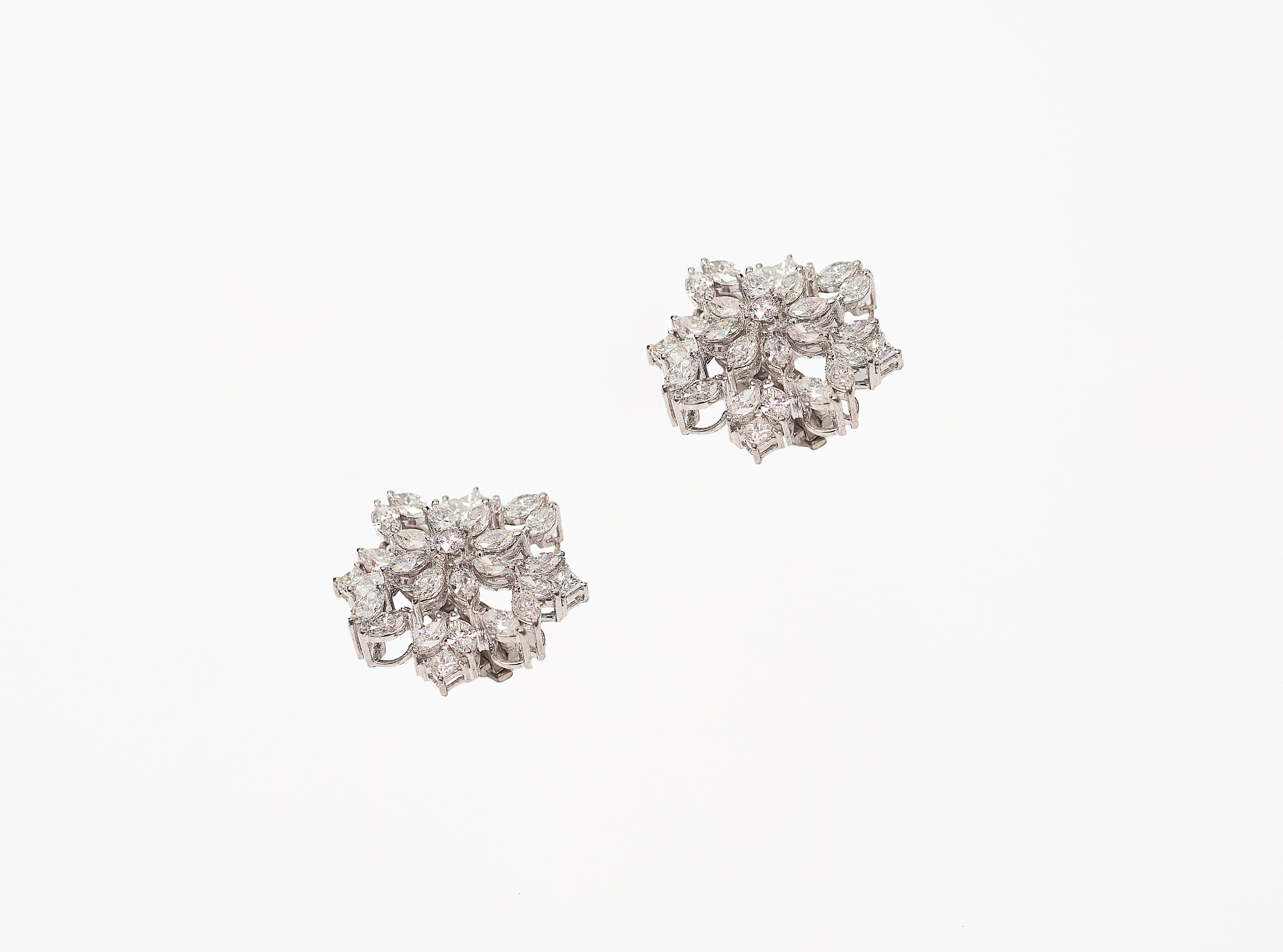 Handcrafted Earring Studs in 18K Gold studded with Marquise and Round Shape Diamonds.
Gold weight - 18.762 gms
Diamond Clarity - VS-Si
Colour - F-G
Post and Clip System