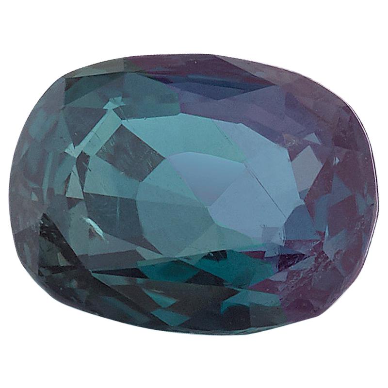 This .78 carat alexandrite chrysoberyl is a gorgeous teal green color in fluorescent/daylight with a 100% color change to purple in incandescent light. It is an oval cushion shape measuring 5.79 x 4.73 x 3.02 millimeters, with a pretty shape that