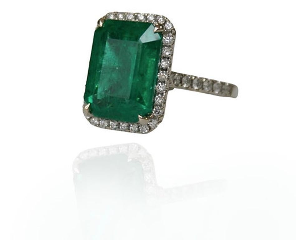 Emerald Weight: 7.82 CTs, Measurements: 14x10.8 mm, Diamond Weight: 0.59 CTs, Metal: 18K White Gold, Gold Weight: 5.45 gm, Ring Size: 6.5, Shape: Emerald Cut, Color: Green, Birthstone: May
