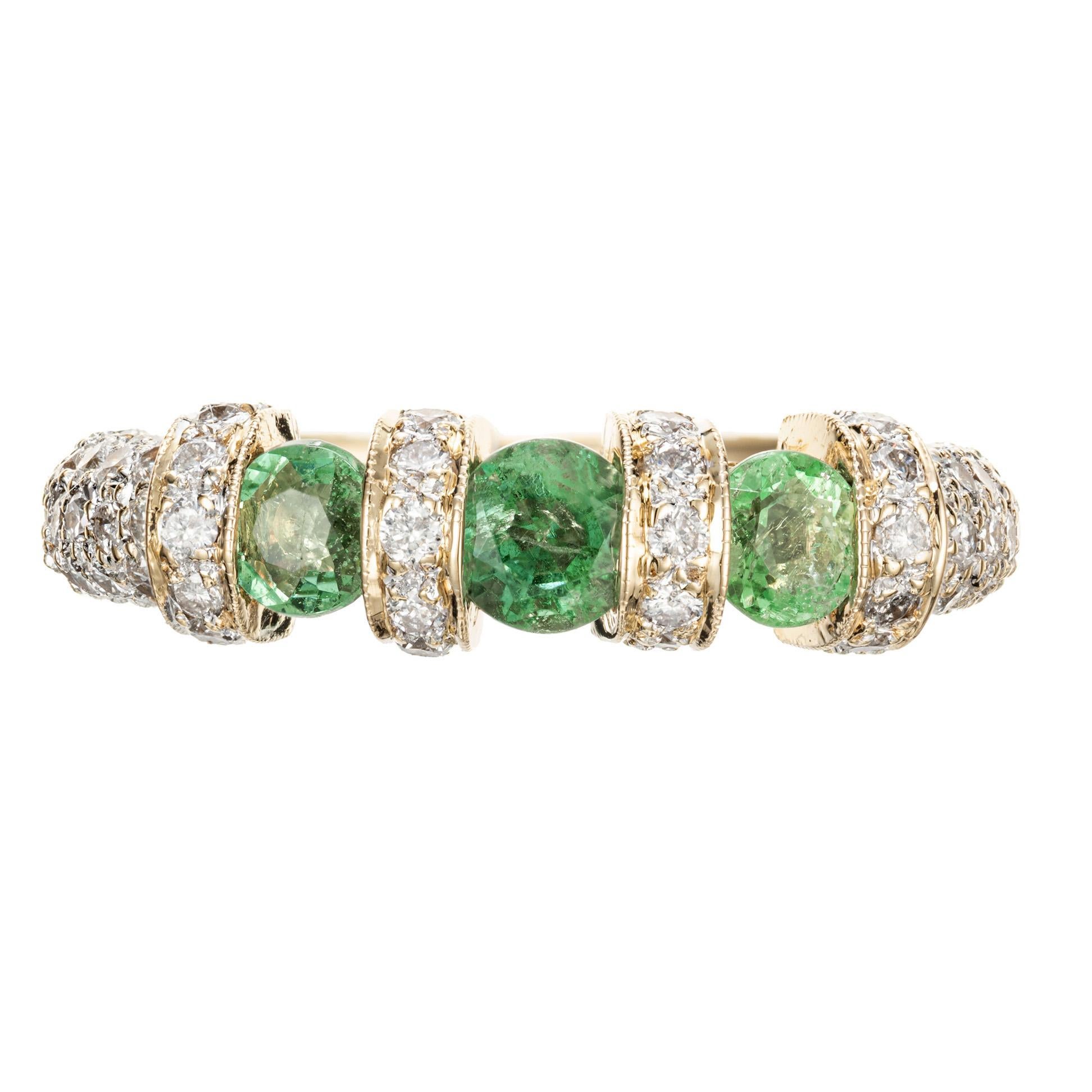 Emerald pave diamond wedding band ring. 3 round cut bright emeralds with 86 round accent diamonds in 18k yellow gold.  

1 round bright green Emerald, approx. total weight .32cts, MI
2 round bright green Emeralds, approx. total weight .46cts, MI
86