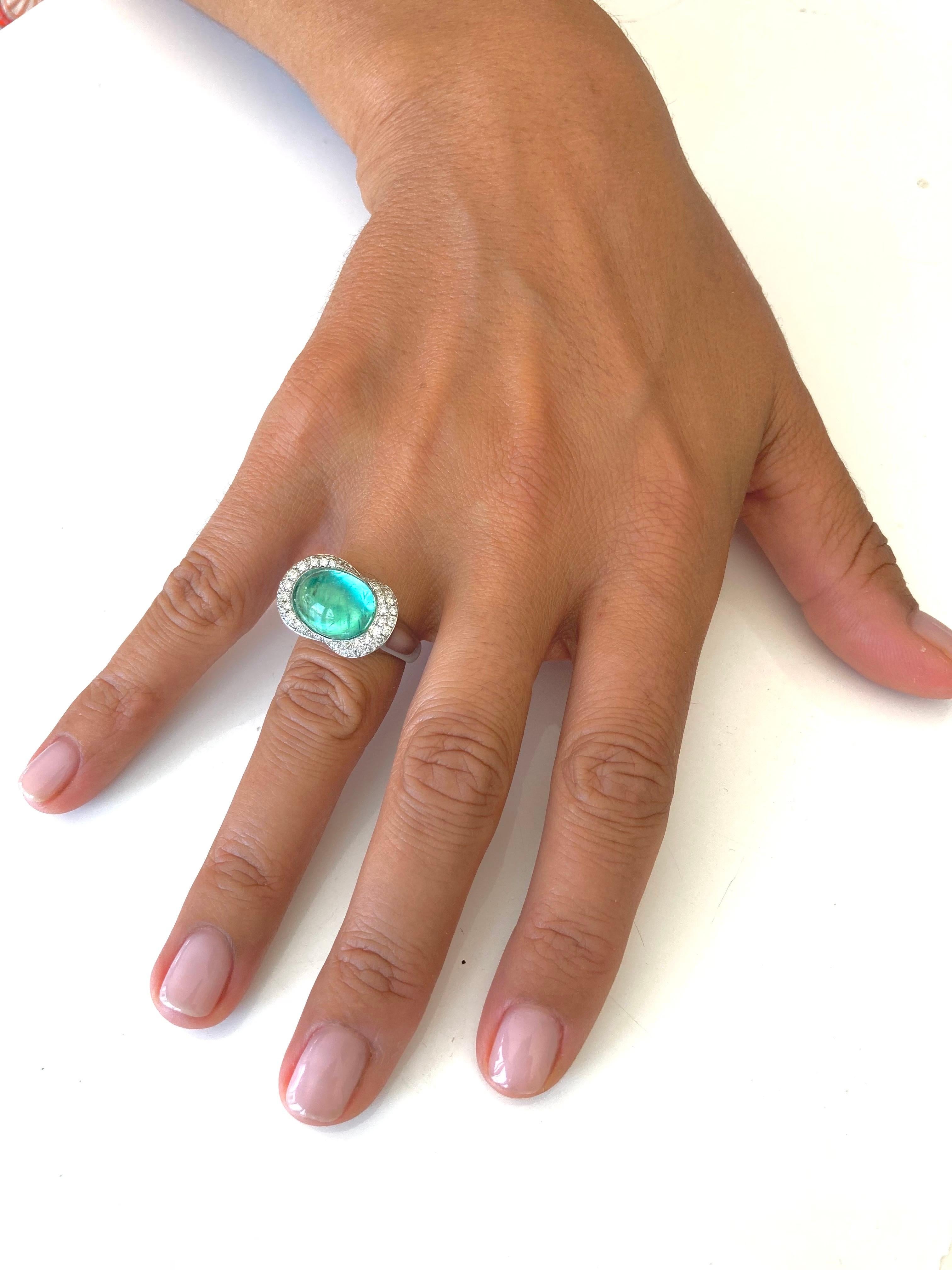 11.53 Grams of white gold nest this beautiful 7.8 Ct Paraiba Tourmaline from Brazil. Recognizable by their inclusions, the rare gem is mounted on a mirror plate which gives it a cat's eye effect.  This design is amazingly comfortable.
