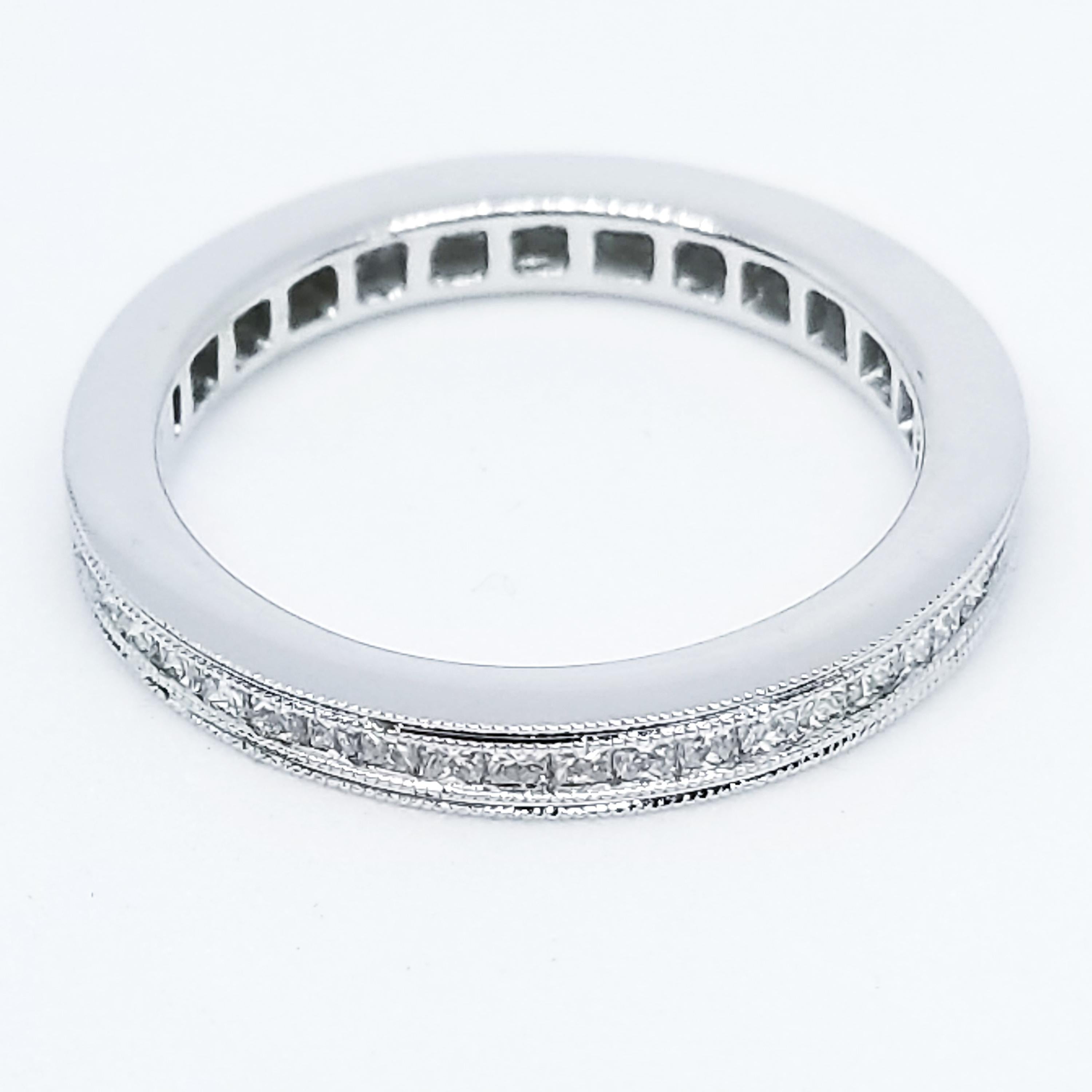 A Classic, Channel set, Princess Cut Diamond Eternity Band features forty-eight Square Princess Cut Diamonds of 0.78 Carats total weight set entirely around the band. The White Diamonds are of G Color and Vs-Si1 Clarity. The Band features Highly