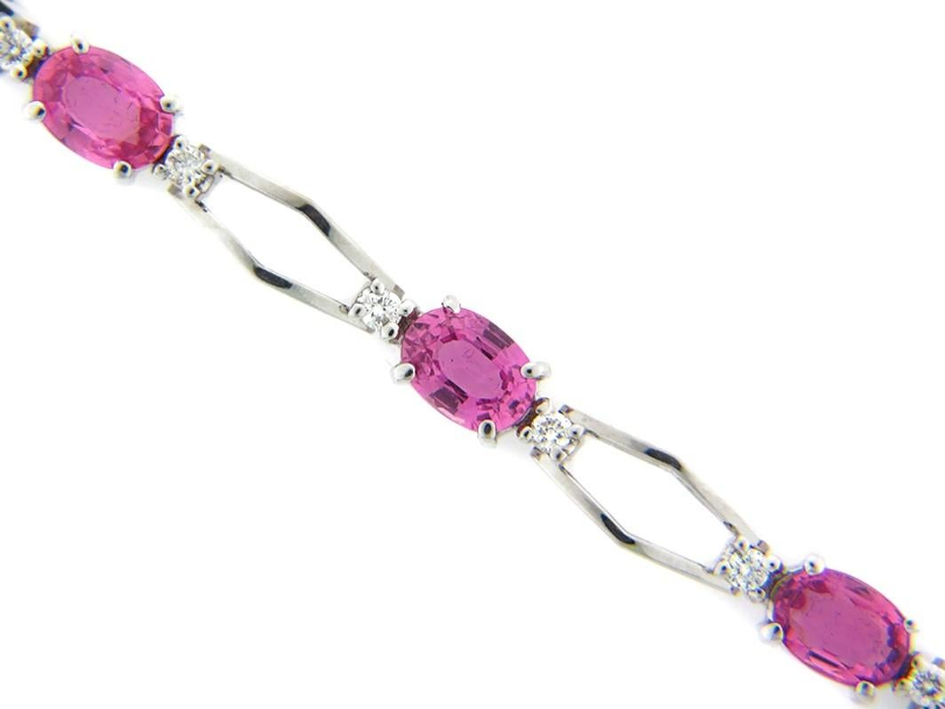 This stunning Pink Sapphire and Diamond Bracelet features 8 beautiful Oval Pink Sapphires, each flanked by a Radiant Round White Diamond on either side. This Bracelet is set in 14k White Gold —  is 6 1/2 inches in length and is secured with a box