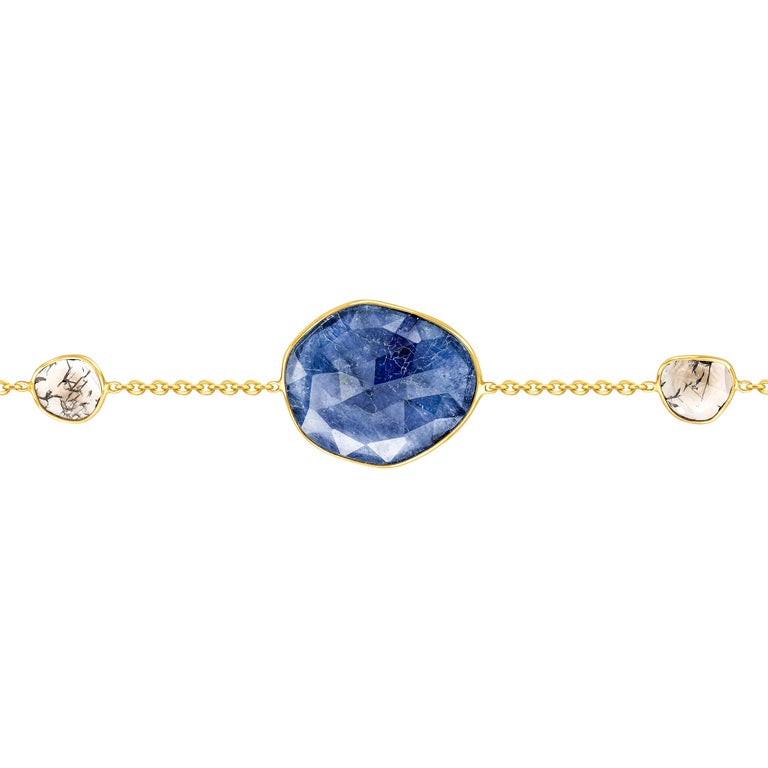 Adorn your wrist with this beautiful 7.45 Carat Rose Cut Blue Sapphire Bracelet from the Artisan Collection features a 0.35 Carat in two Diamond slices set in 18 Karat Yellow Gold. Each piece is hand made with a unique shaped precious stone in the