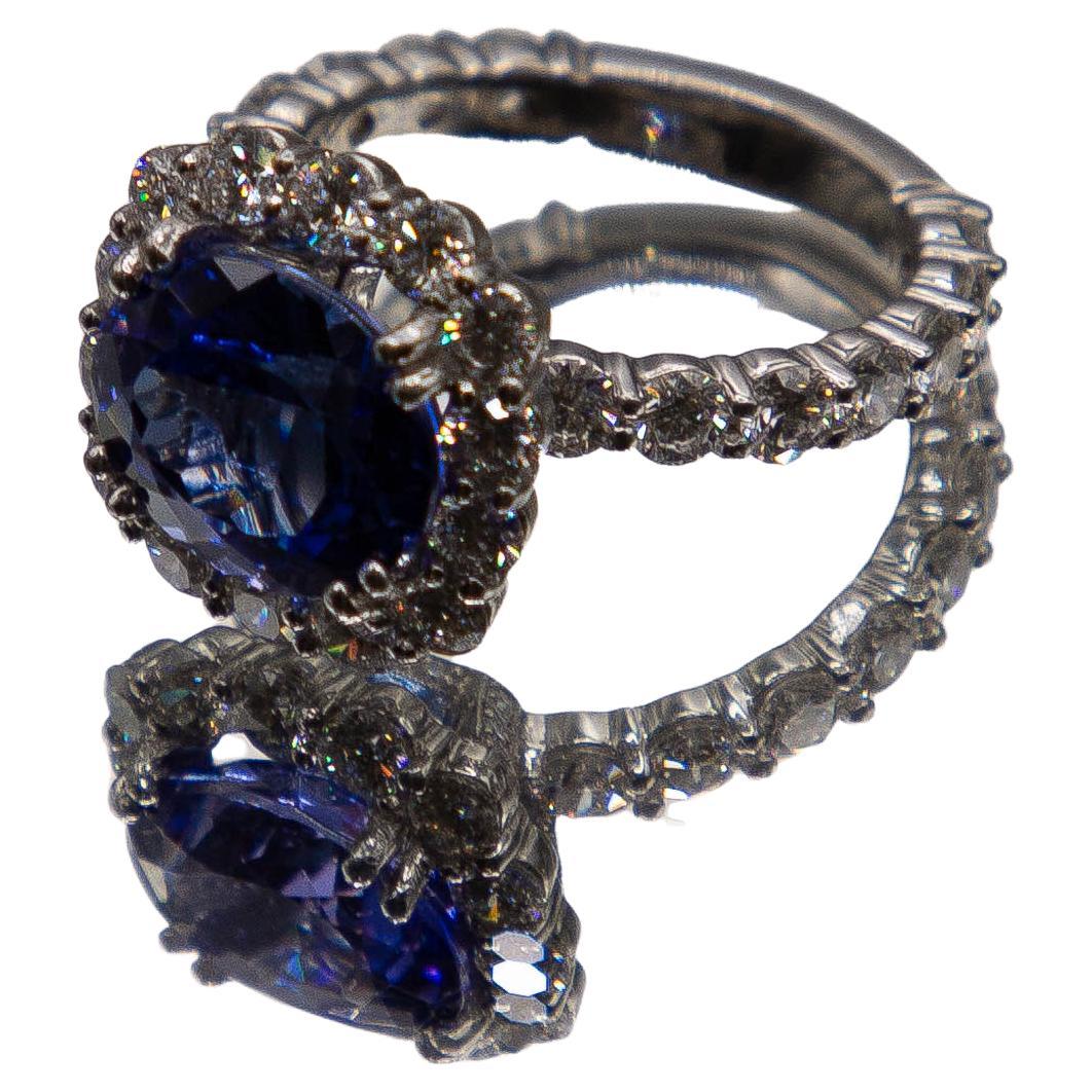 A highly transparent oval Ceylon sapphire weighing 4.48 carats sets securely in eight prongs atop this masterfully built 950 platinum ring. The near flawless center gem radiates a rare, ever- so -slightly violetish- blue and is outlined by top