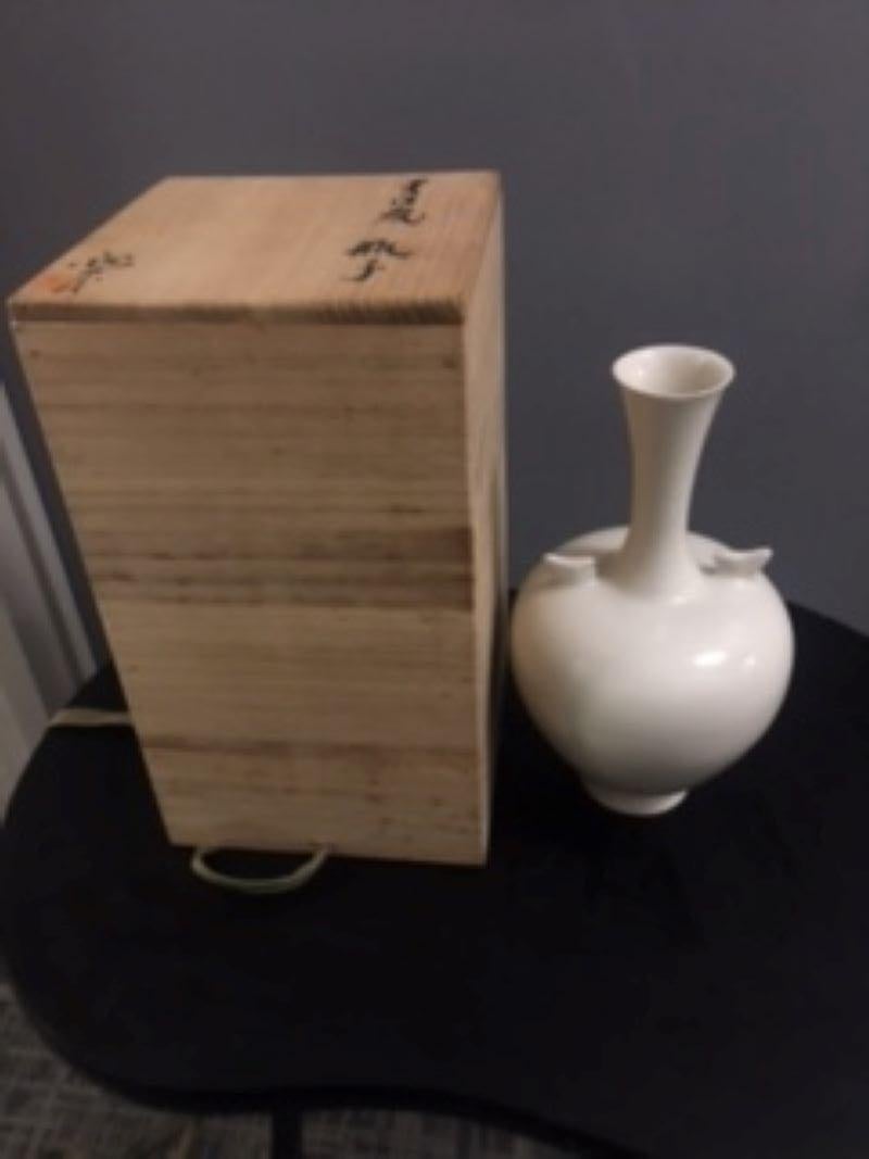 781 Japanese Mashiko-ware White porcelain Glaze vase. Emperor Showa from 1926 to 1989 Period, Ca. 1980. 10” high x 5 ½” wide. Signed box. Mashiko is a folkware kiln site that is unlike some of the other older kiln sites around Japan. The town is
