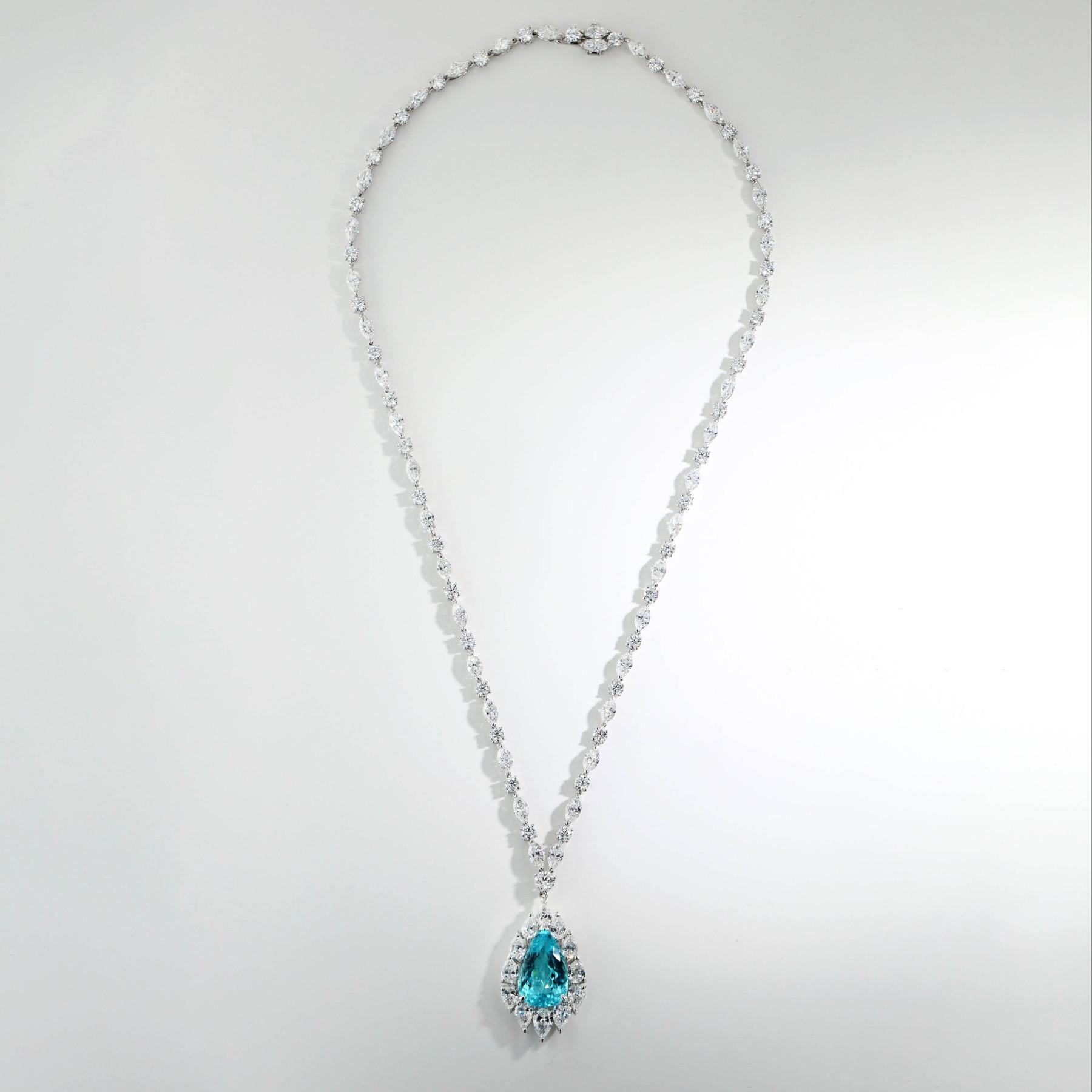 7.81cw pear shape paraiba tourmaline gemstone set into an 18k white gold necklace with marquise and round diamonds. This necklace showcases the rare and exquisite beauty of the paraiba tourmaline. The paraiba tourmaline is a type of gemstone that