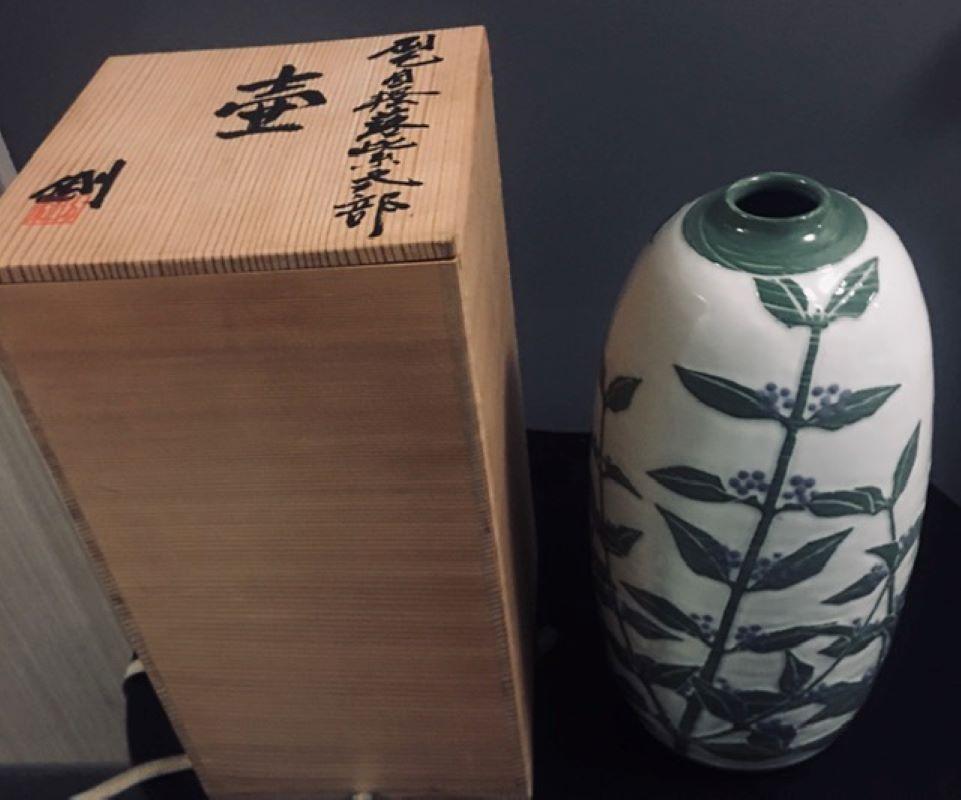 Emperor Showa from 1926 to 1989-1990. Measure: 13 ½” high. Singed Tsuyoshi with signed box. Features a fine white glaze with green leaves and blue berries glaze. Tall classic shape a dynamic masterpiece Seto ware (???, Seto-yaki) is a type of
