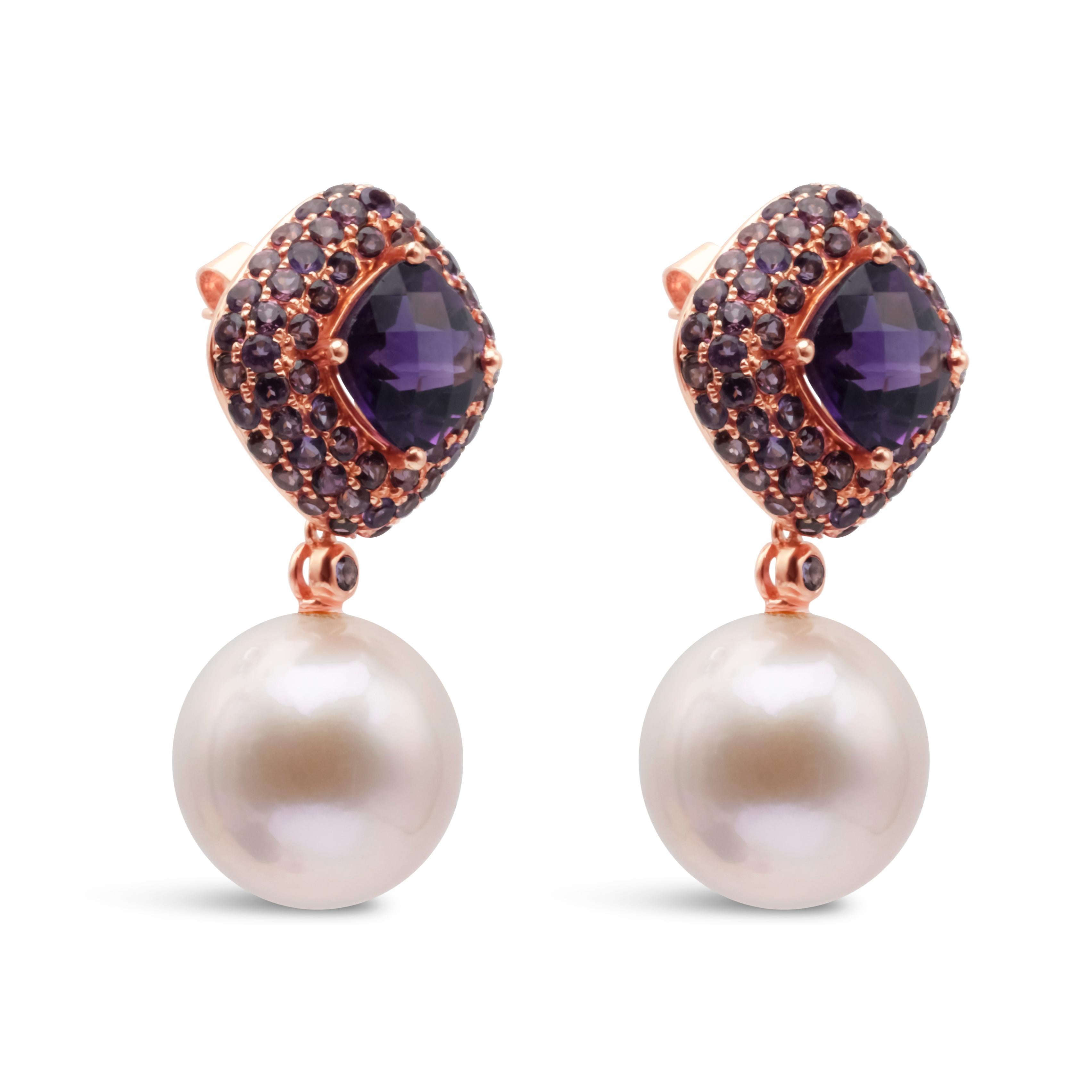 A stunning and elegant earrings showcasing an amethyst center weighing 4.81 carats surrounded by gorgeous garnet gemstones in a pave setting weighing 3.03 carats total. Features a 14-15mm dangling south sea pink pearls. Made in 18k Rose Gold.

Style