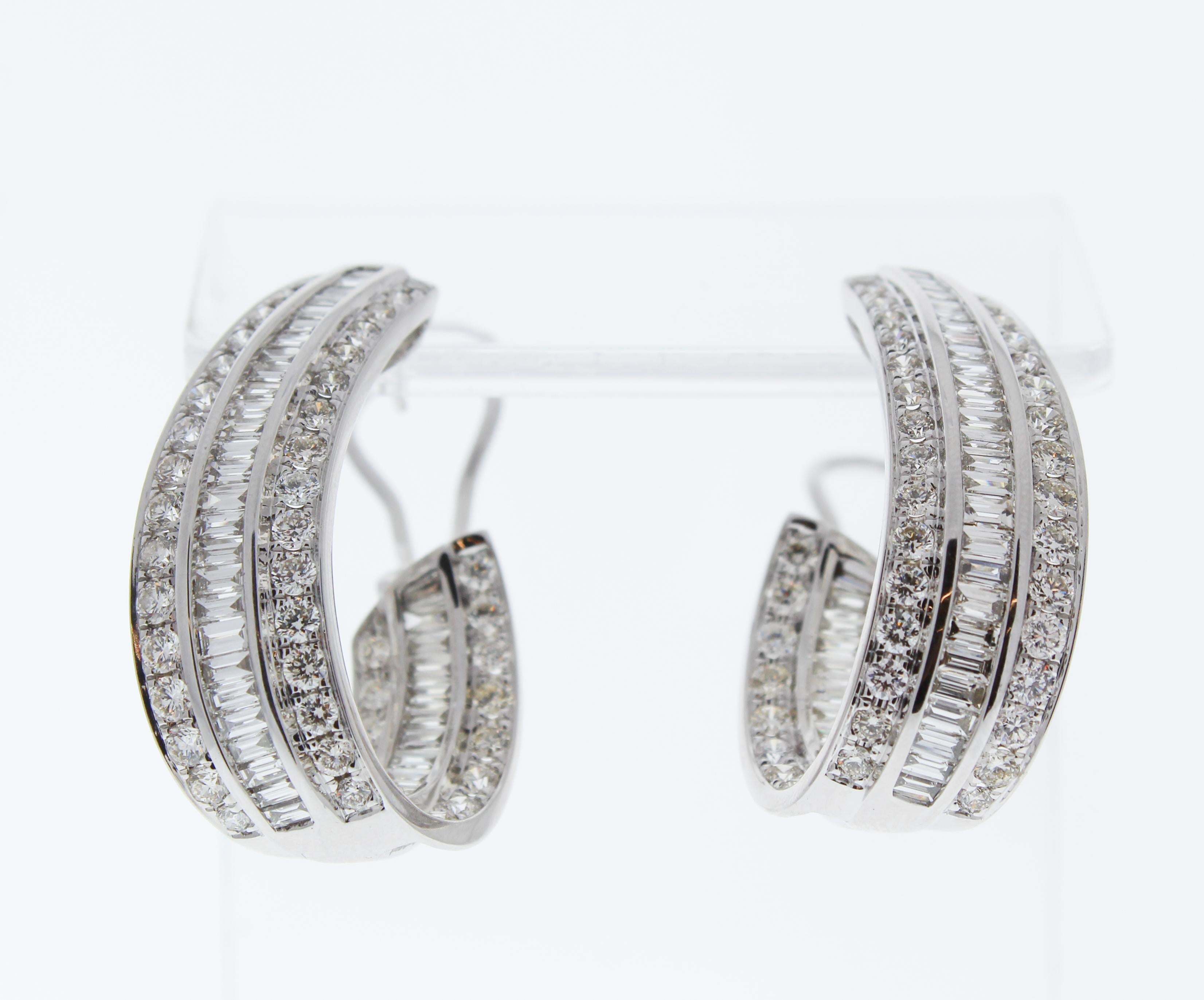 These 18k white gold j-hoop earrings feature one hundred seventy-seven baguette and round brilliant cut diamonds channel set in decadent swirls on the front and inside. These gorgeous inside out diamond hoops make the ultimate present for an