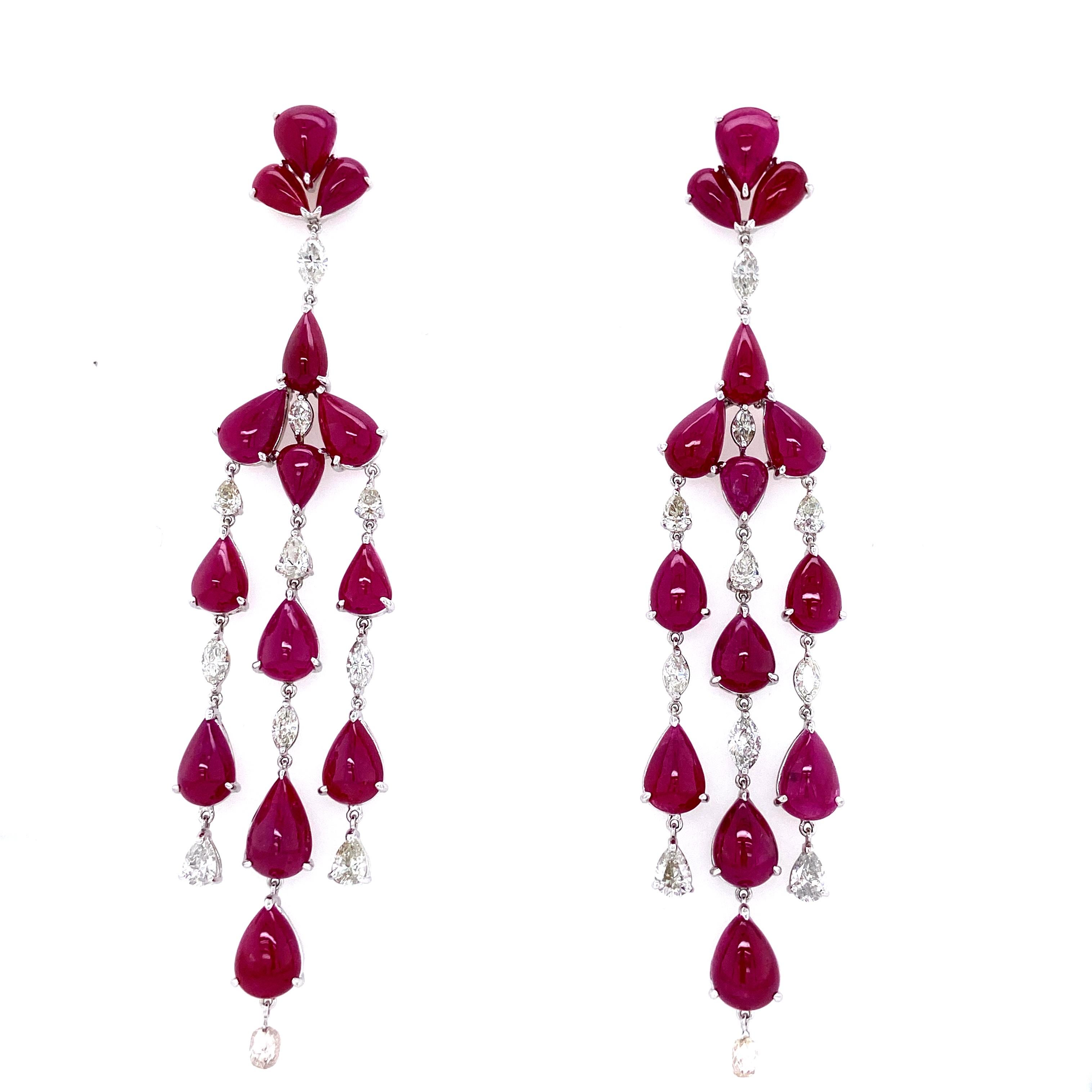 78.50 Carat Natural Ruby Cabochons and White Diamond Gold Chandelier Earrings:

A beautiful chandelier earring, it comprises of natural ruby cabochons weighing 78.50 carat, accented by white diamonds weighing 6.71 carat. The rubies are of intense