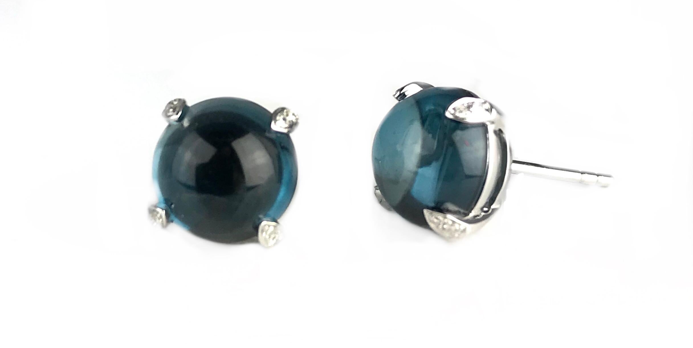 These beautiful earrings feature 7.86 carats cabochon blue topaz. The prongs are embellished with 0.06 carats diamonds.

Set in 14k white gold, these earrings would be a welcome addition to any jewelry box.

Diamond Town is pleased to offer a