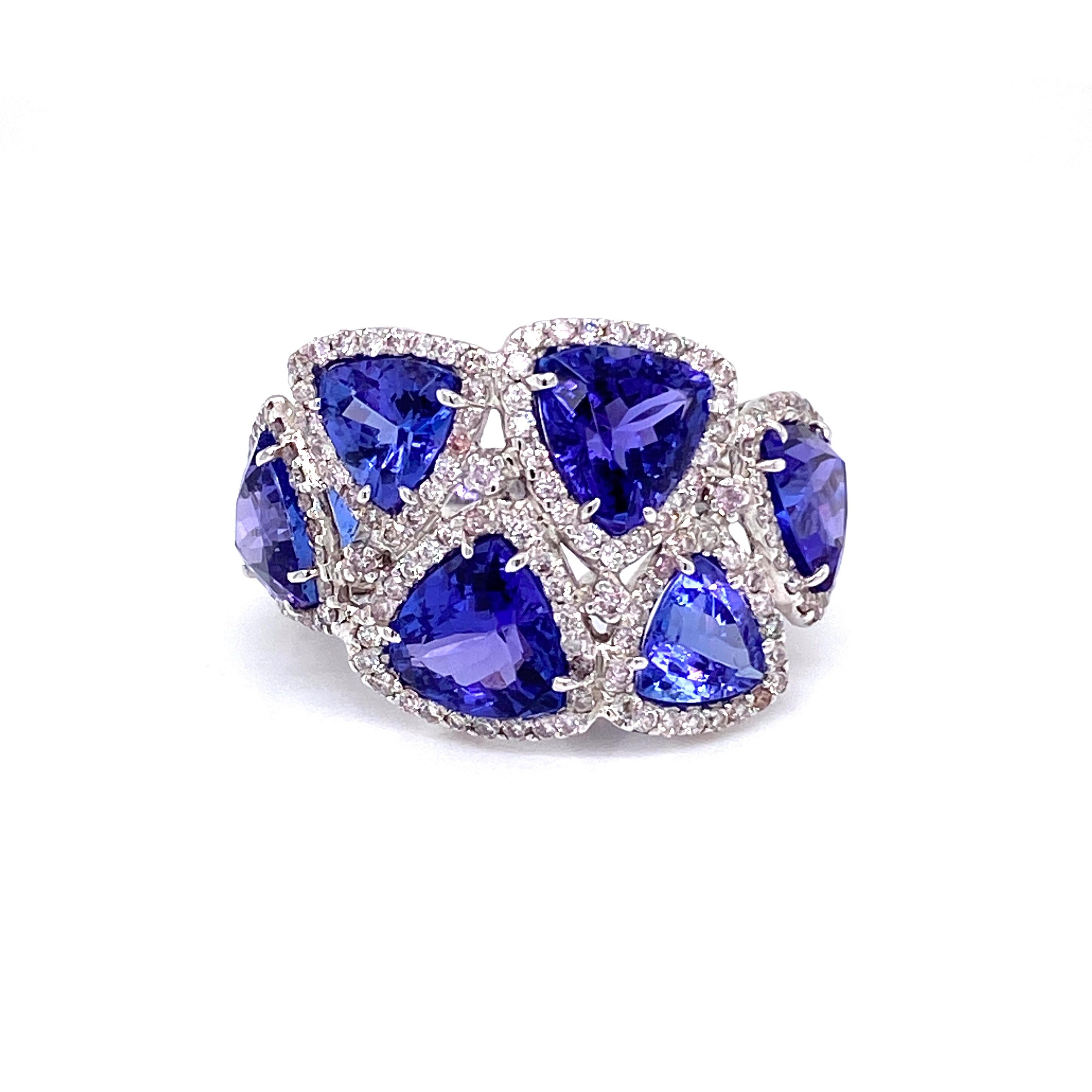 This stunning cocktail ring features six Trillion Tanzanites (total of 7.86 Carats) surrounded by Round White Diamonds (total of 1.08 Carats). 
This ring is set in 18k White Gold. Ring Size is 6 1/2.