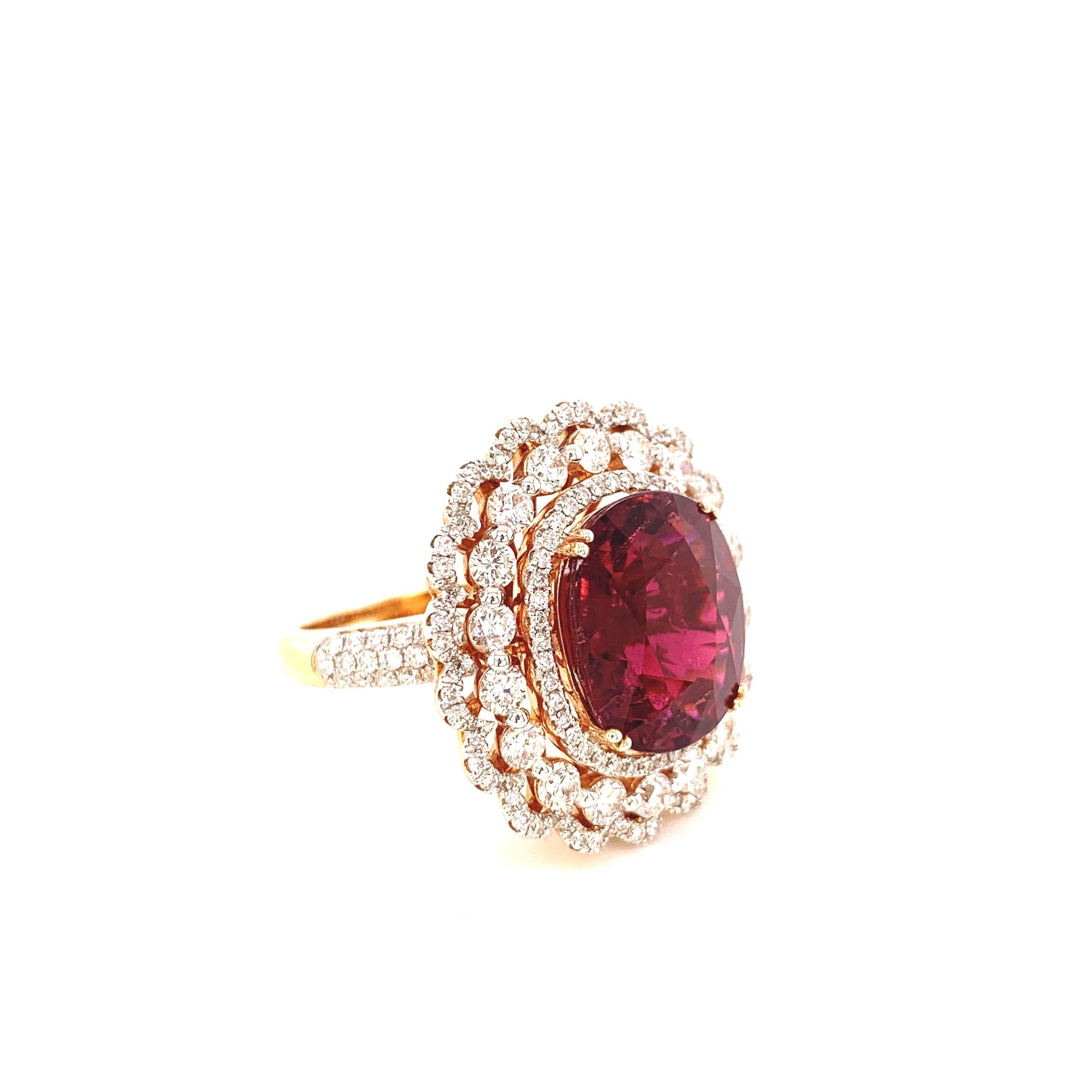 Glamorous tourmaline diamond cocktail ring. High lustre, transparent, deep reddish-pink, 7.87 carats cushion brilliant-cut natural tourmaline (known as rubellite) set in high profile, encased in basket mounting with eight bead prongs. Accented with