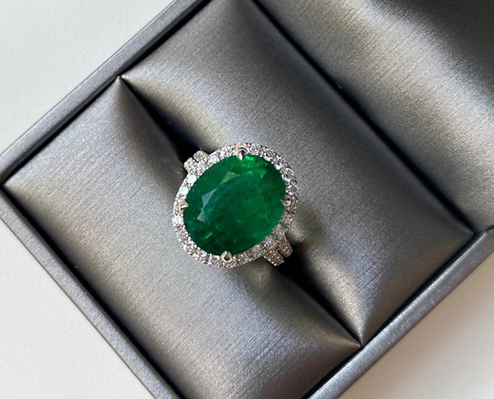 Emerald Weight: 7.87 CTS, Diamond Weight: 1.00 CT, Metal: 18K White Gold, Ring Size: 6.25, Shape: Oval, Color: Green, Hardness: 7.5-8, Birthstone: May