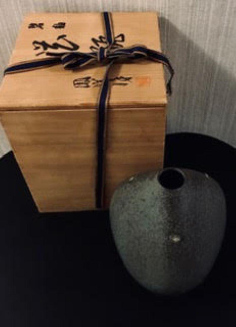 Japanese Kiyomizu-ware singed ,features a fine gray glaze with flex of black glaze ,vase of dramatic oval form with mon accents, signed box. Kiyomizu ware (???, Kiyomizu-yaki) is a type of Kyo ware traditionally from Gojozaka district near Kiyomizu