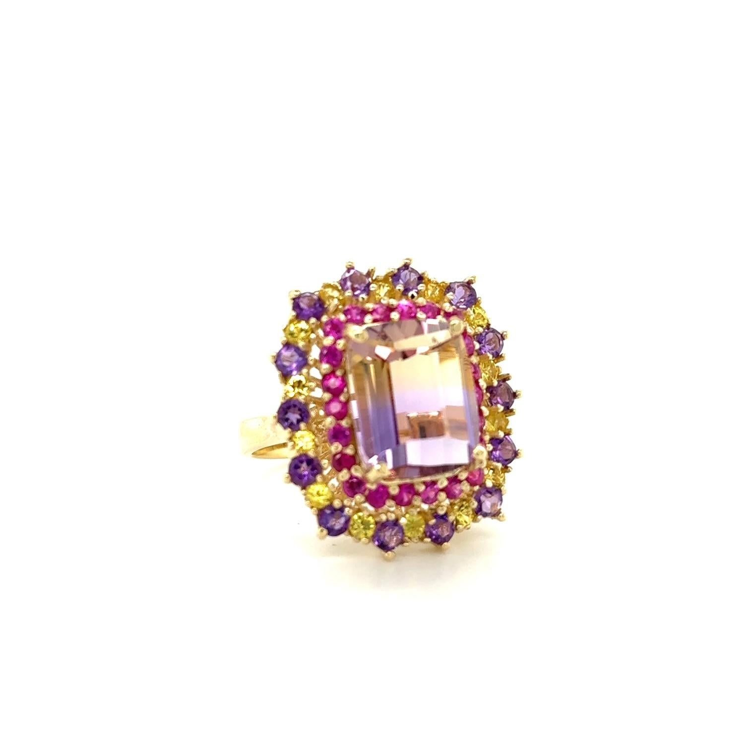 7.88 Carat Ametrine Sapphire Diamond Yellow Gold Cocktail Ring

This ring definitely has a WOW factor!  
Flashing a vivid color of yellow and purple the vibrant Emerald Cut Ametrine sits between Yellow and Pink Sapphires and Diamond accents.  

Item