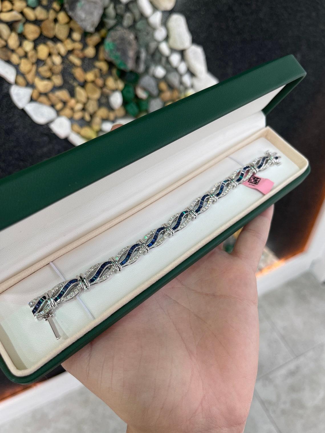An ultra-luxurious sapphire and diamond bracelet. This elegant piece features high-quality, intense dark blue sapphires with remarkable qualities. Varying from baguette to tapered baguette cut, and channel set within. Multiple brilliant round-cut