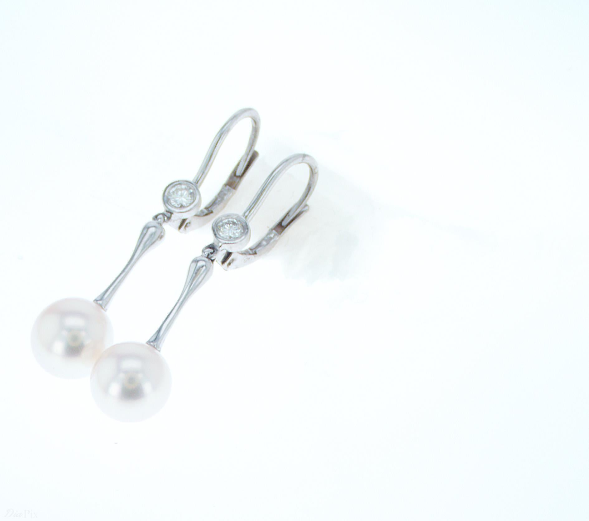 7.8mm Pearl Dangle Earrings with 0.14ct total weight of accent Diamonds. Set in a Platinum top with 18k White Gold Leverbacks.