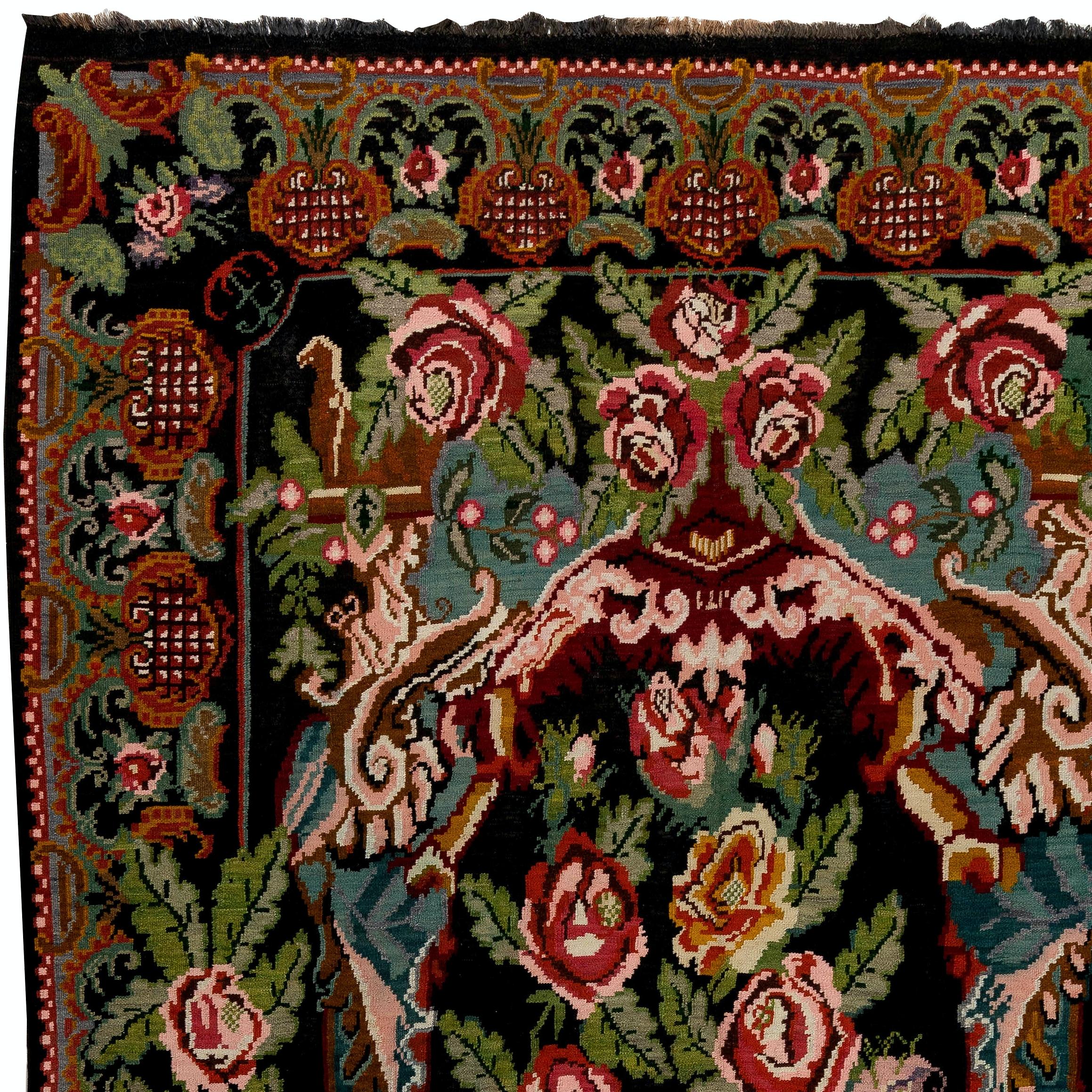 One of a kind vintage Bessarabian Kilim. 
A handwoven Eastern European Rug from Moldova. These traditional Moldovan flat-weaves are inspired from vintage Aubusson carpets but they are distinguished with their black grounds, large floral patterns in
