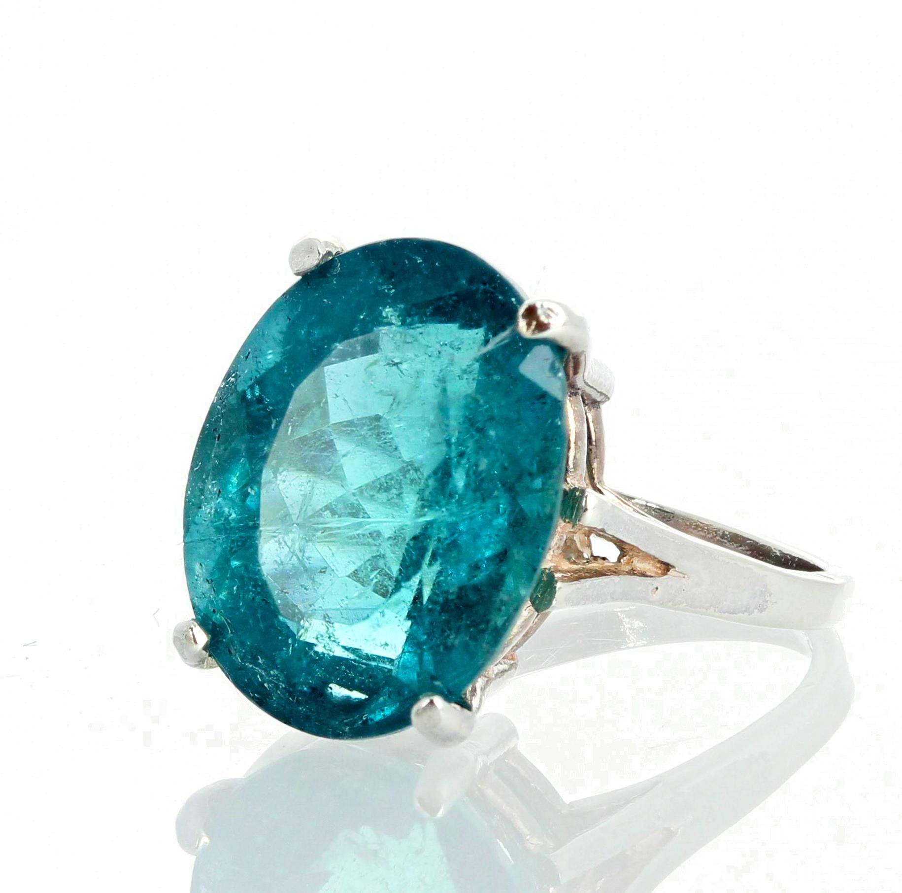 Glorious blue rare 7.9 carat Brasilian  Indicolite Tourmaline (15 mm x 11 mm) set in a sterling silver ring size 7 (sizable).  The natural tiny flecks inside the stone make it glitter intensely.