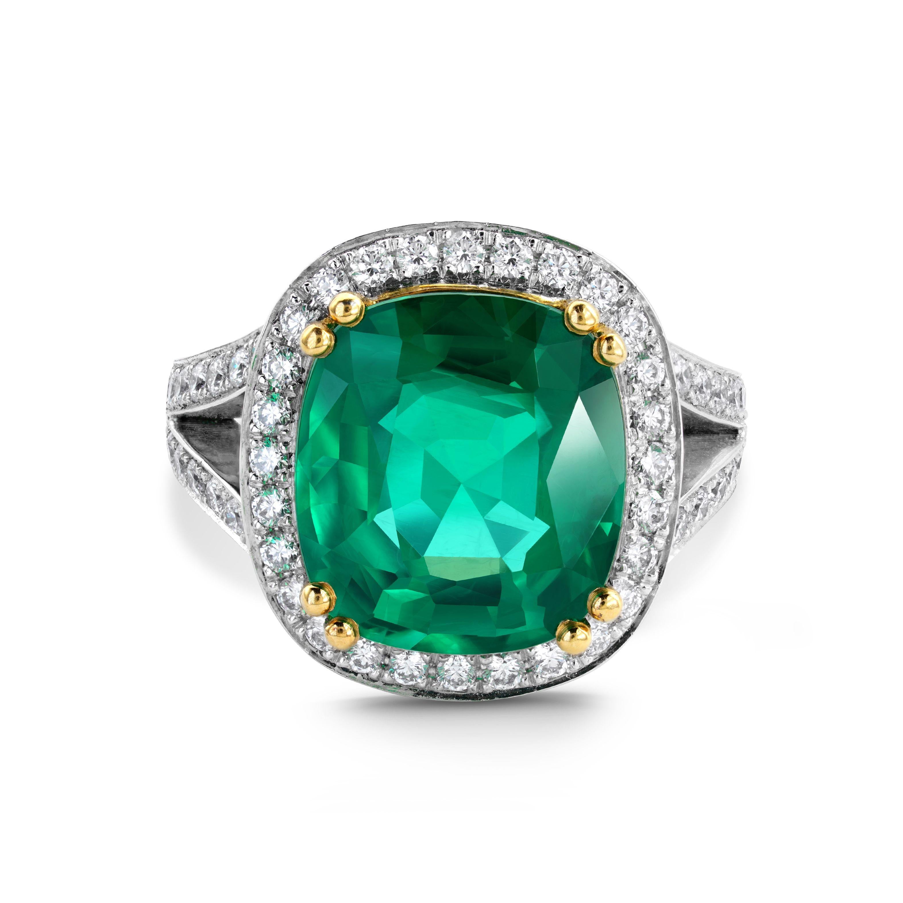 Beautiful Finely detailed 7.90 Carat Emerald Ring, surrounded by and accented on shoulders with a total of 56 round cut diamonds, weighing approx 0.80ct; clarity SI1; color H/I; GIA certificate attached. Exquisitely Hand crafted in 18 Karat yellow