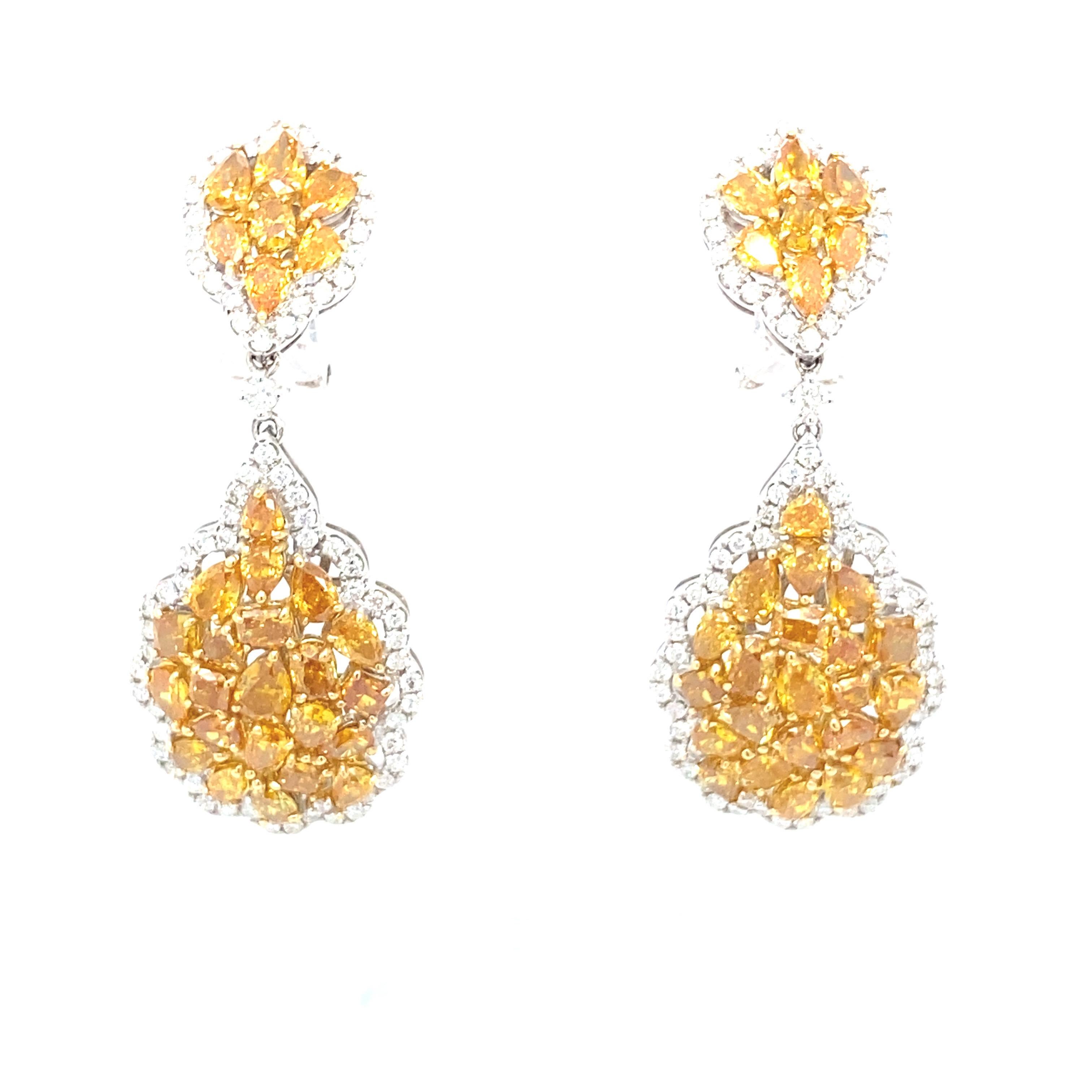 The spectacular radiance of these majestic cluster of multi color diamonds give this chandelier earrings a stunning look! 
Diamond: 7.90 carat Multi Color Fancy Shape
Diamond: 1.46 carat White
Gold: 18K Two Tone
