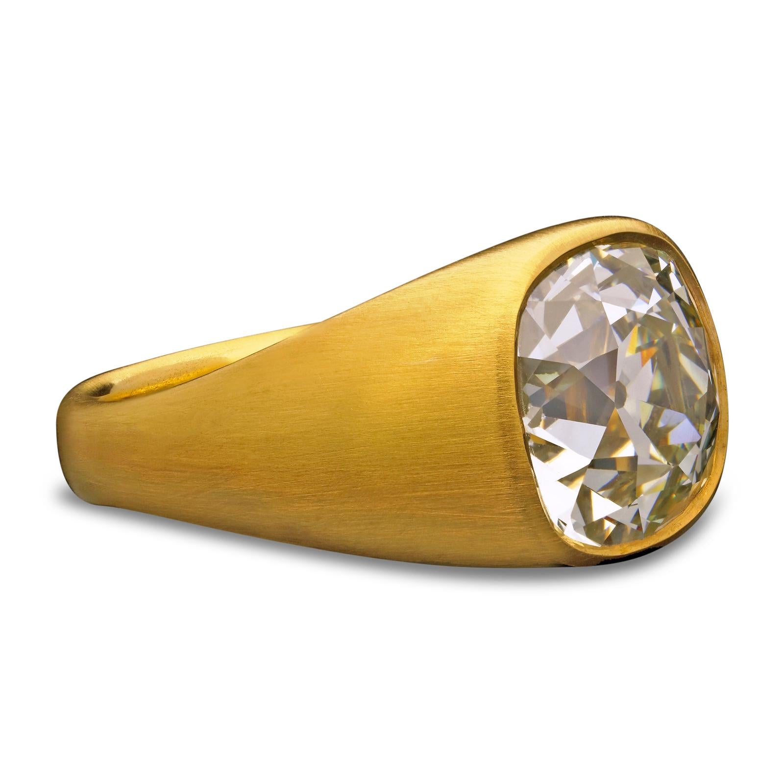 A stunning yellow gold and old-cut cushion shaped diamond gypsy-set ring by Hancocks, set flush to the centre with a wonderfully bright and lively old mine brilliant cut diamond weighing 7.90ct within a beautifully hand-crafted mount of rich 22ct