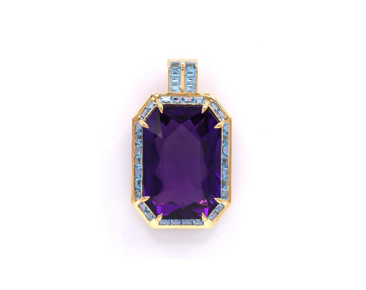 This stunning necklace featuring blue topaz and quartz is inspired by oriental motives. This great 66.46 Ct 31.20 x 21.40 x 13.70 mm purple quartz is beautifully displayed on 18 K yellow gold and 38 blue topaz frame. This impressive gem pendant is