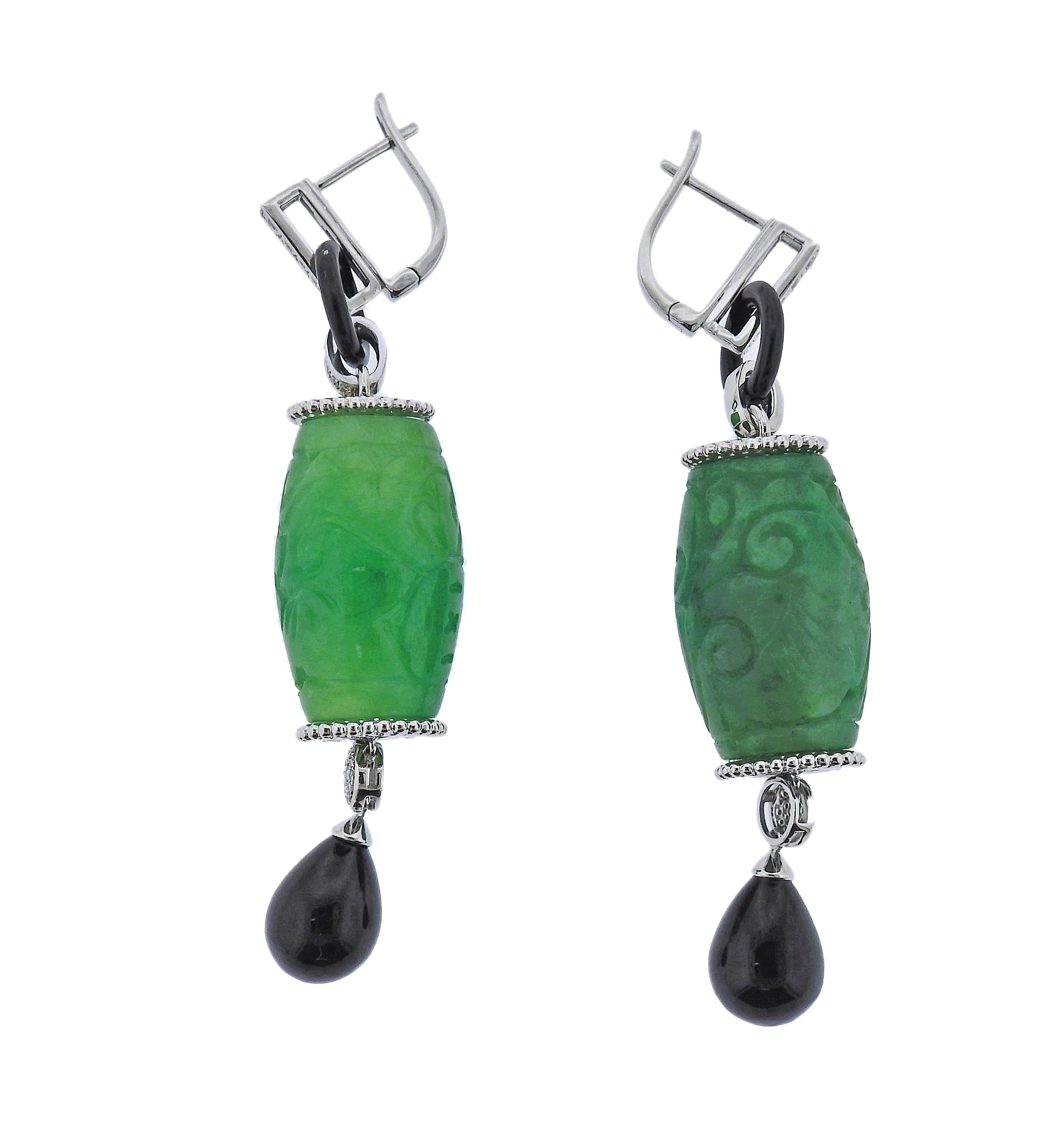 Pair of 14k gold drop earrings, with 79.38ctw carved  jadeite jade, onyx and 0.28ctw in diamonds. Earrings are 65mm long. Marked 585. Weight - 27.4 grams.