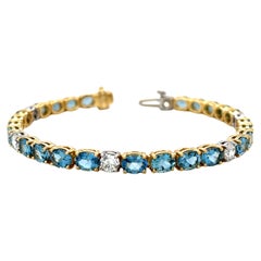 Bracciale tennis con acquamarina ovale e diamanti rotondi da 7,94 carati totali in oro 18 carati