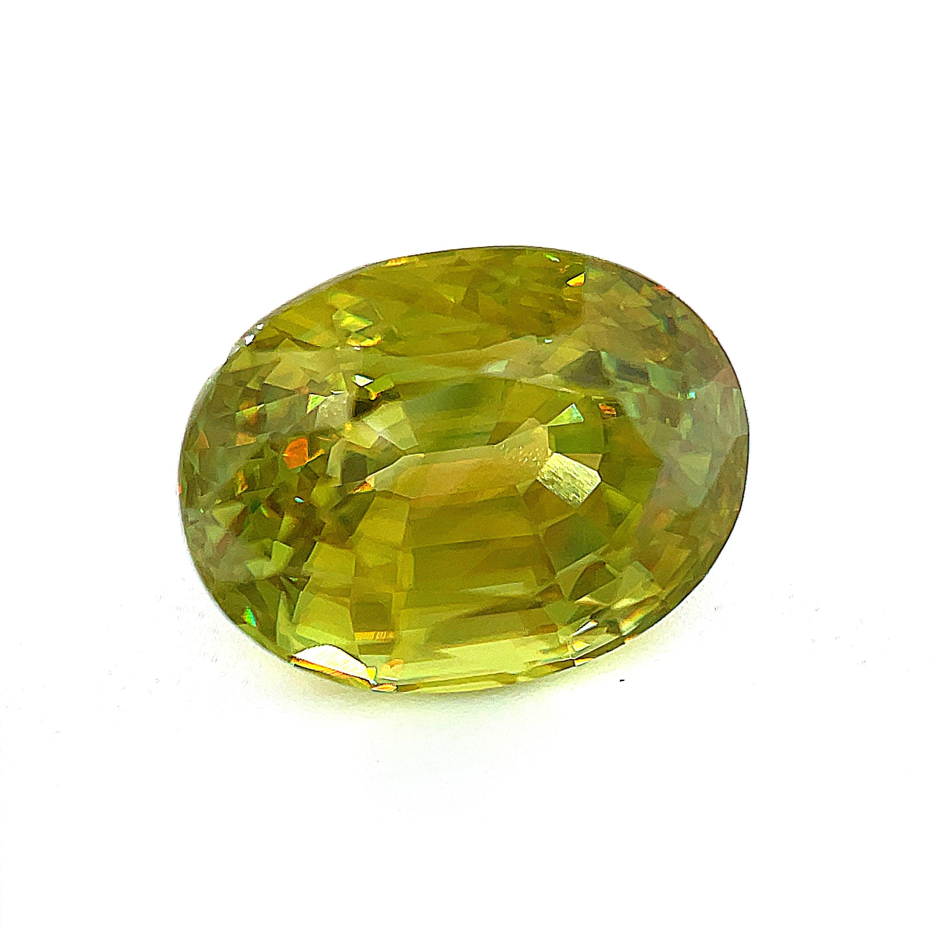 This 7.95 carat oval-shaped sphene is the perfect example of a rare collector gemstone! Displaying sphene's characteristic dispersion to a superior degree, it shows off brilliant flashes of yellow, orange, and blue simultaneously throughout its