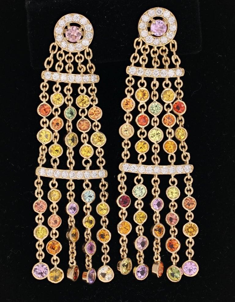 7.95 Carat Multi Color Sapphire Diamond Dangle Yellow Gold Earrings.
These earrings have 60 Round Cut Multi Color Sapphires that are falling like a delicate rain fall and weigh 6.70 carats. There are 58 Round Cut Diamonds weighing 1.25 Carats. The