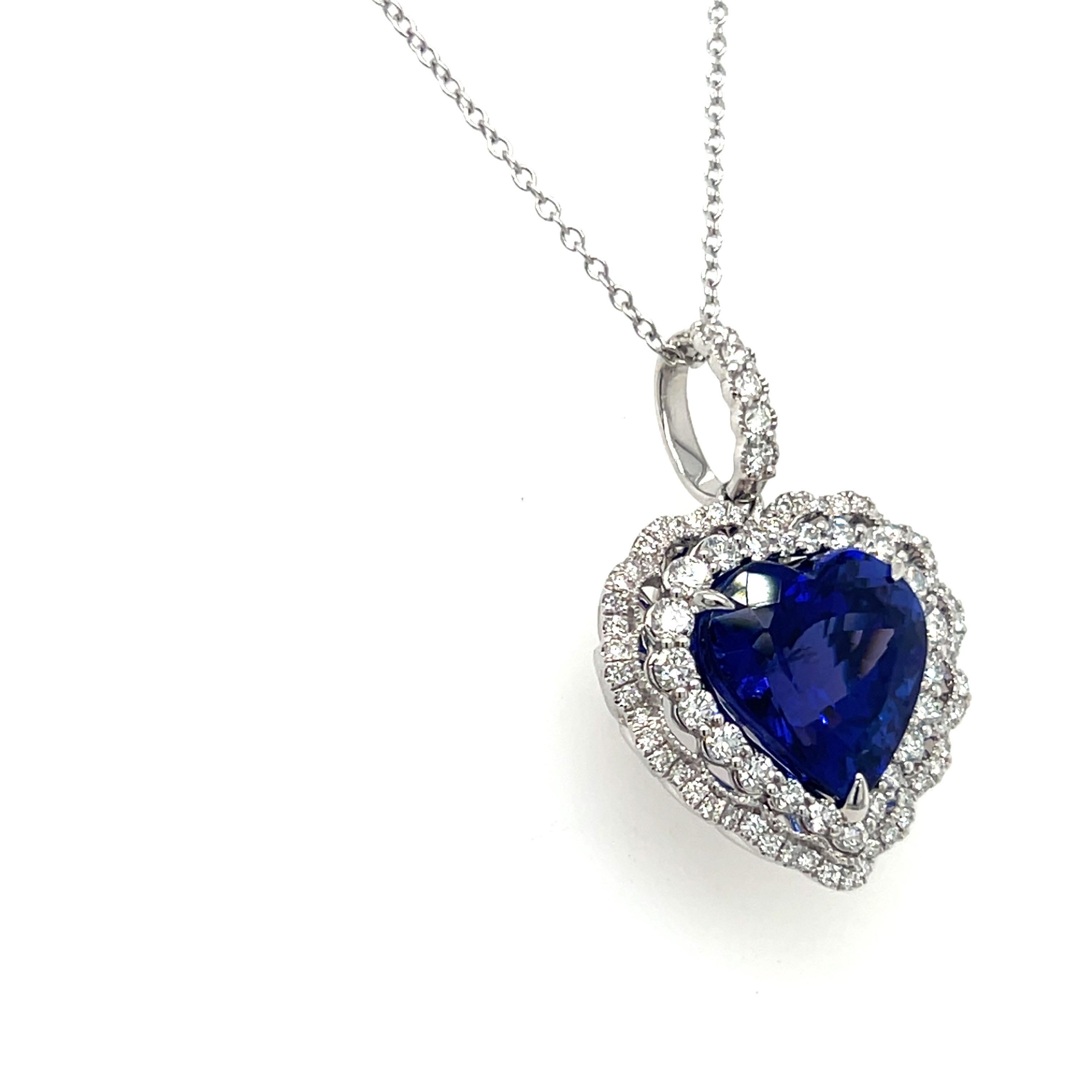 This beautiful pendant showcases a vivid 7.19-carat tanzanite, with its stunning blue hue taking center stage. The stone is elegantly surrounded by a double row of white diamonds, adding extra sparkle and brilliance. The intricate back gallery