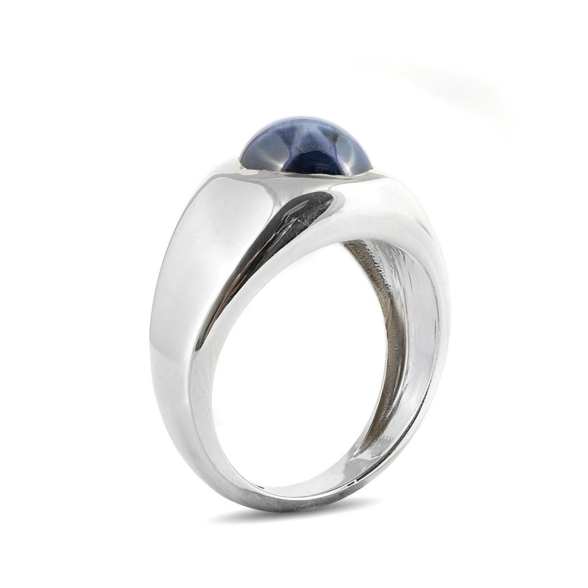 This bold white gold men's ring is a true standout, featuring a magnificent 7.96-carat Star Sapphire. The gem's hypnotic blue hues make the star pattern come alive, offering a mesmerizing and sharp six-rayed reflection that radiates from the center.