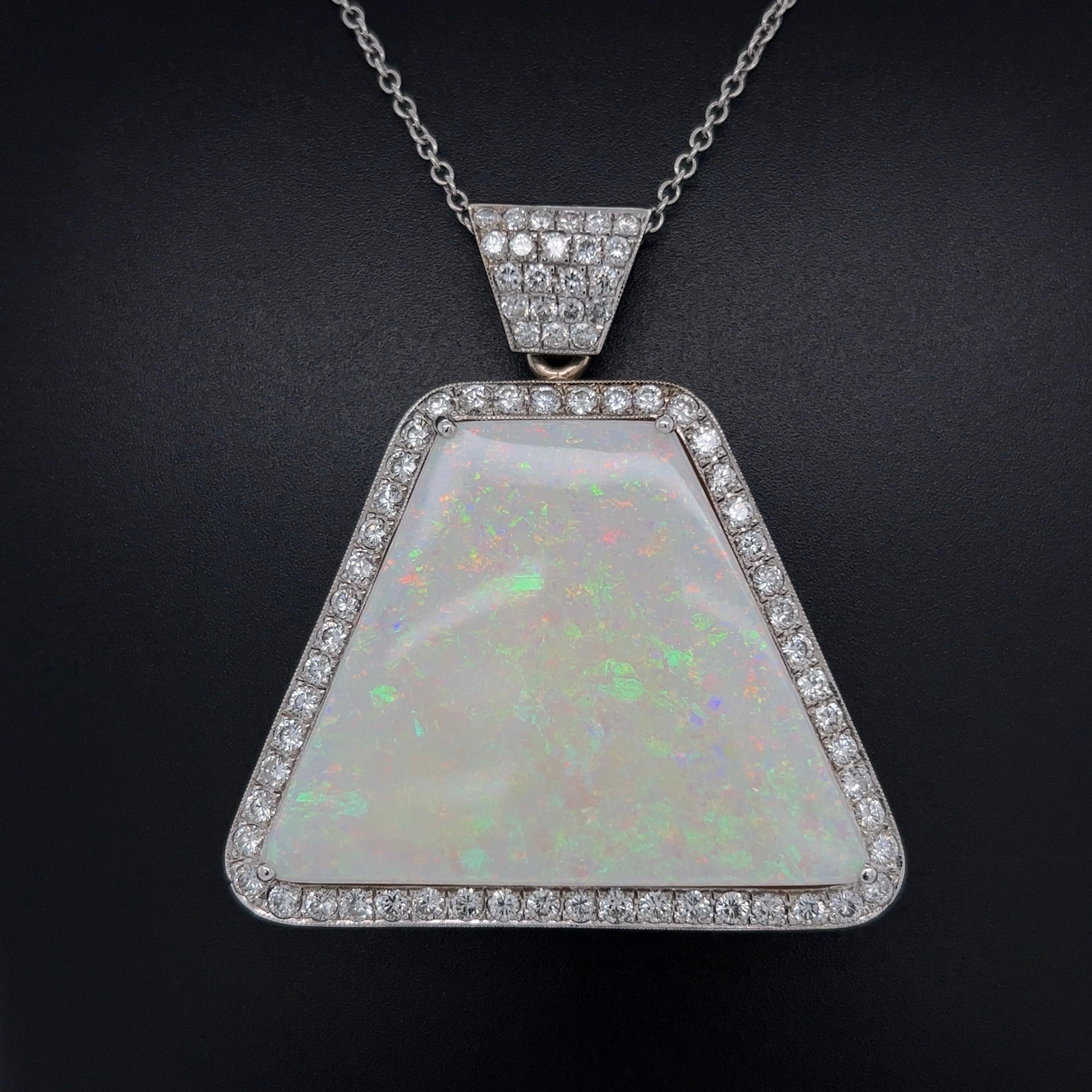 Simply Beautiful! Elegant and finely detailed Gold Pendant Necklace. Hand set with a securely nestled 79.63 Carat Trapezoid Australian White Opal and surrounded by Brilliant-cut Diamonds, weighing approx. 4.04tcw. Pendant size: 2.27” l x 1.06” w.