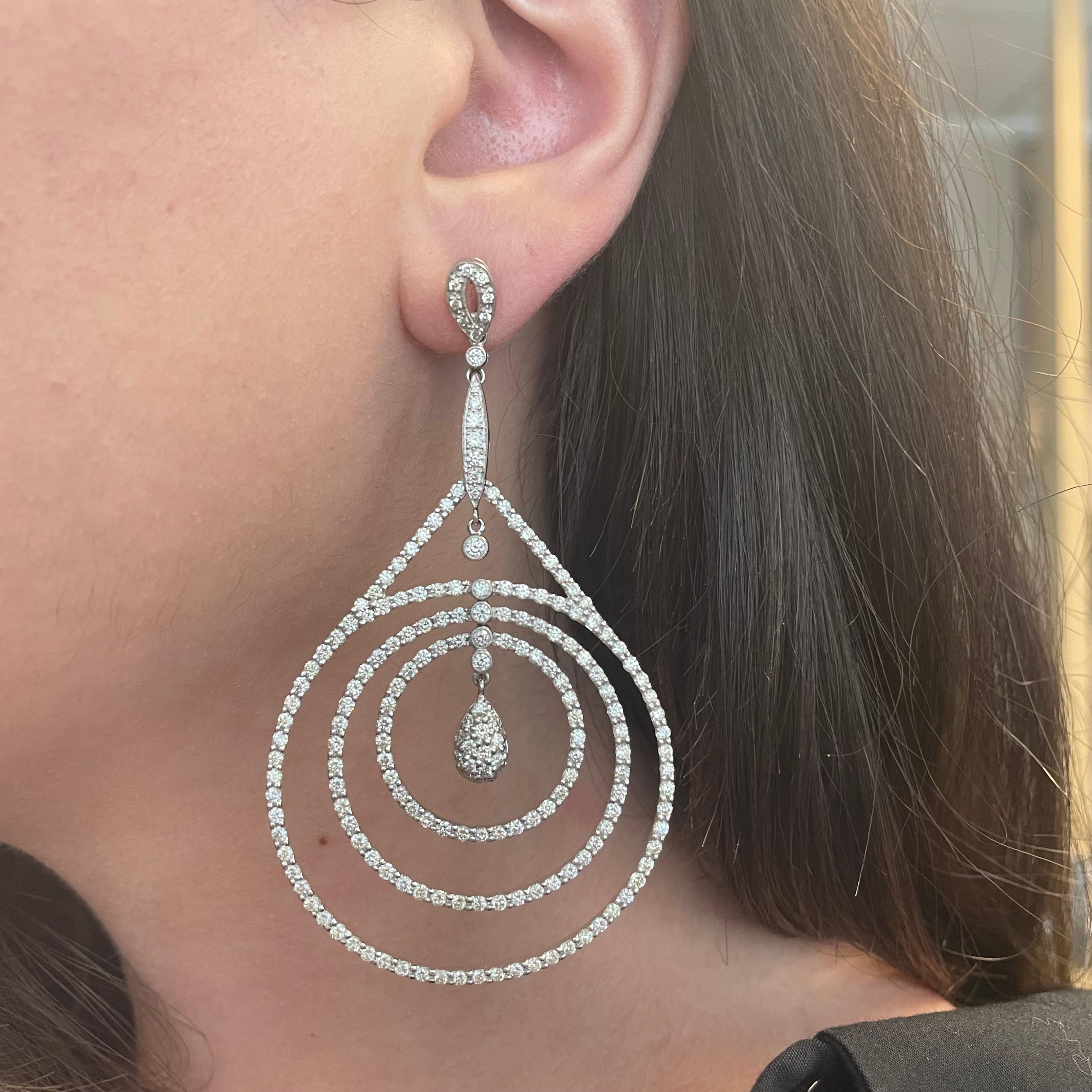 Stunning pave diamond drop earrings.
390 round brilliant diamonds, 7.98 carats total. Approximately H/I color grade and SI clarity grade. Pave, prong, and bezel set, 18k white gold.
Accommodated with an up to date appraisal by a GIA G.G. upon