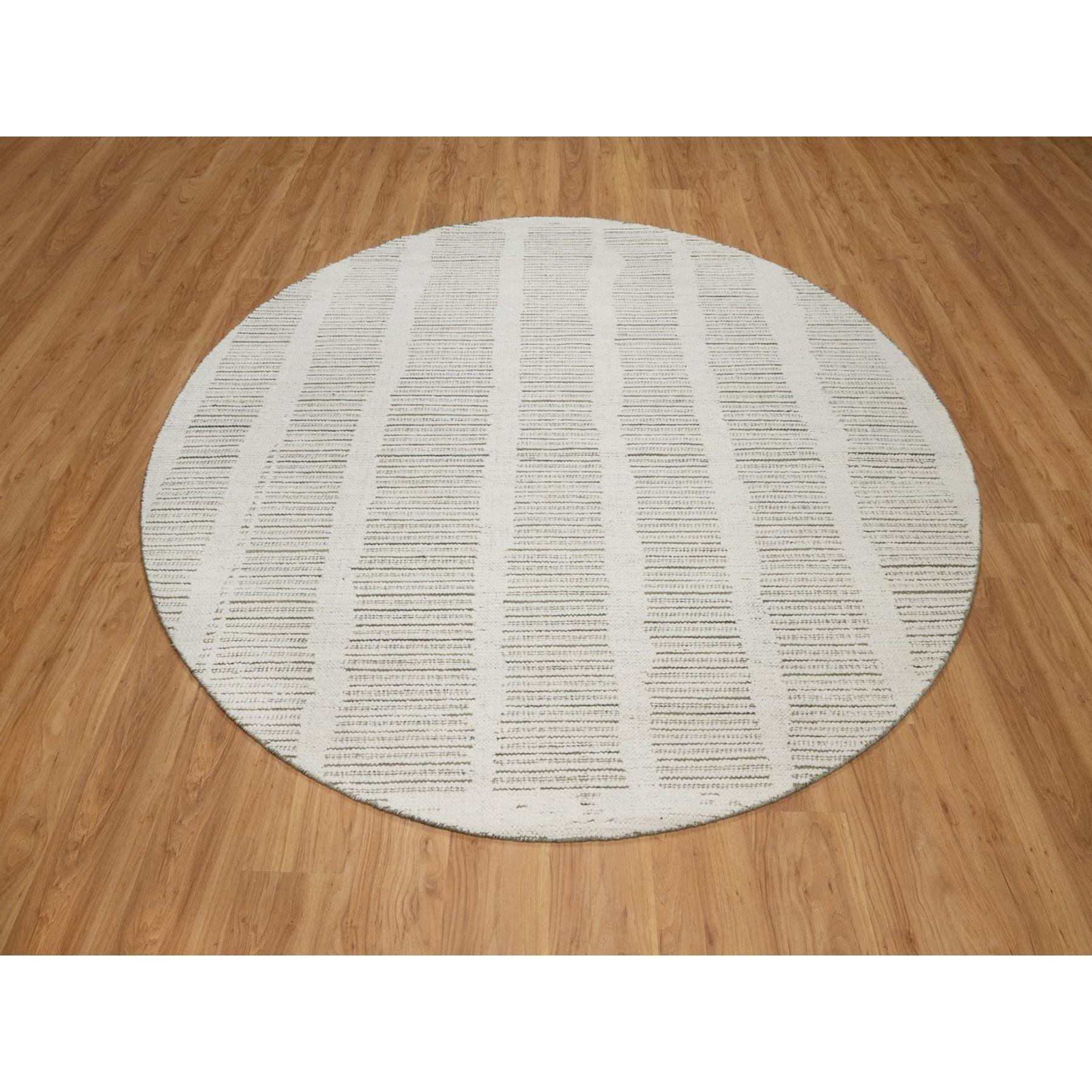 Pearl White, Undyed Natural Wool, Hand Woven, Flat Weave with Pile, Textured, Round, Oriental Rug
Primary materials: Wool
Latex: No Pile 
height: 0.25 Inches
Style: Contemporary
Primary color: Ivory
Secondary colors: Green
Pattern: Oriental